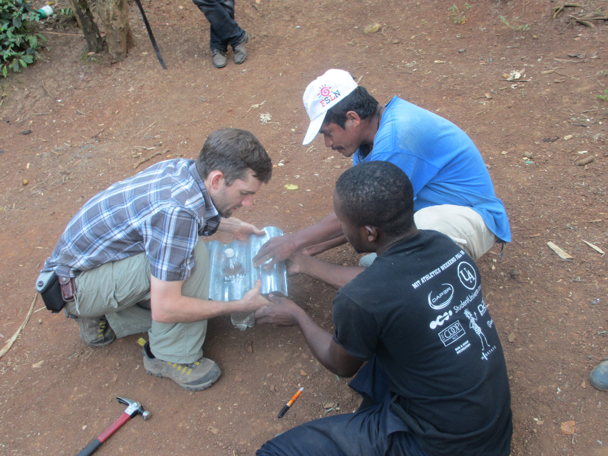 D-Lab Shows a Community Member How to Create a Corrugated Tile to House the Soda Bottle Light
