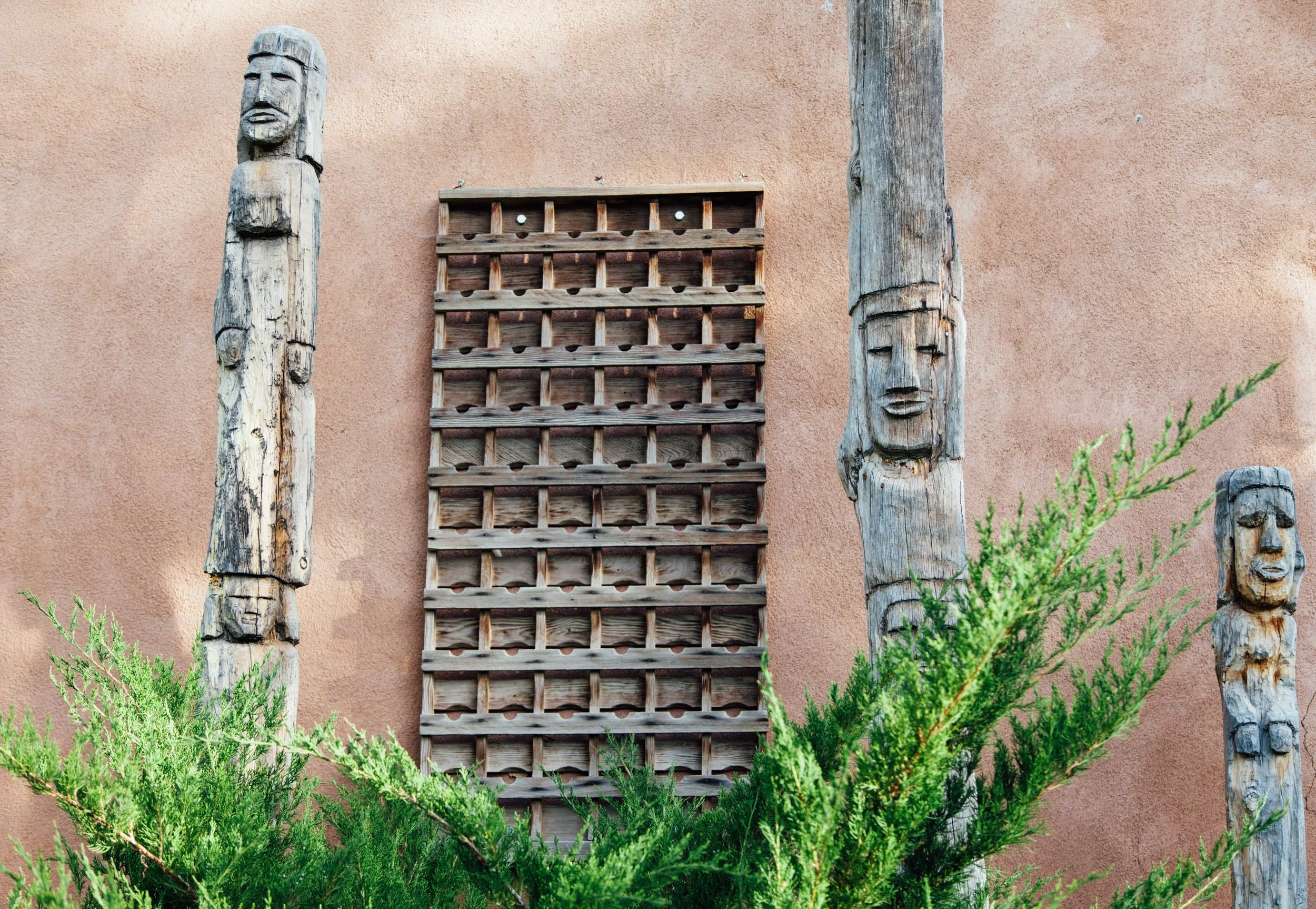 Two wooden totem poles stand on the property where Alchemy of Spirit retreat took place in Taos, New Mexico