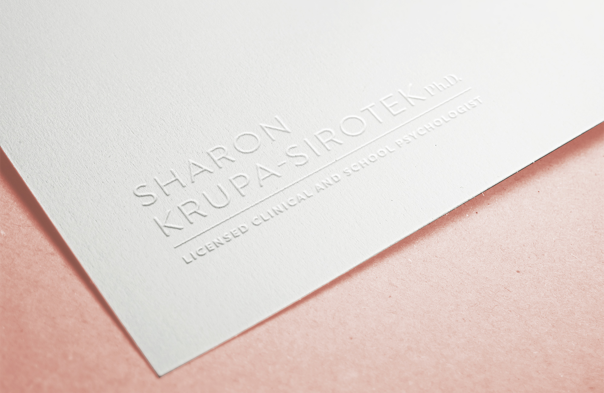 The Sharon Krupa-Sirotek logo embossed on nice paper