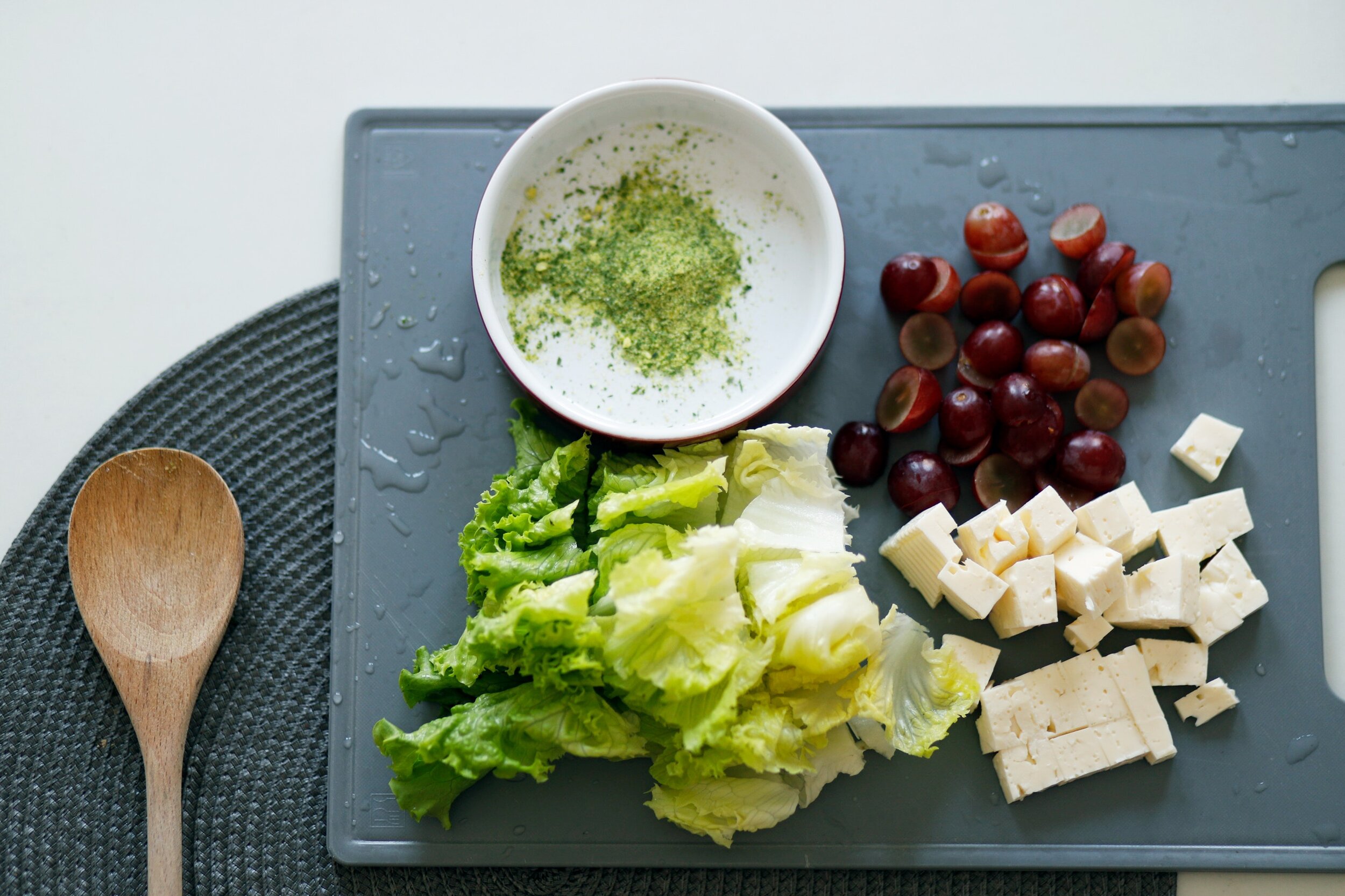 slice-tofu-dates-and-lettuce-on-grey-chopping-board-1563636.jpg