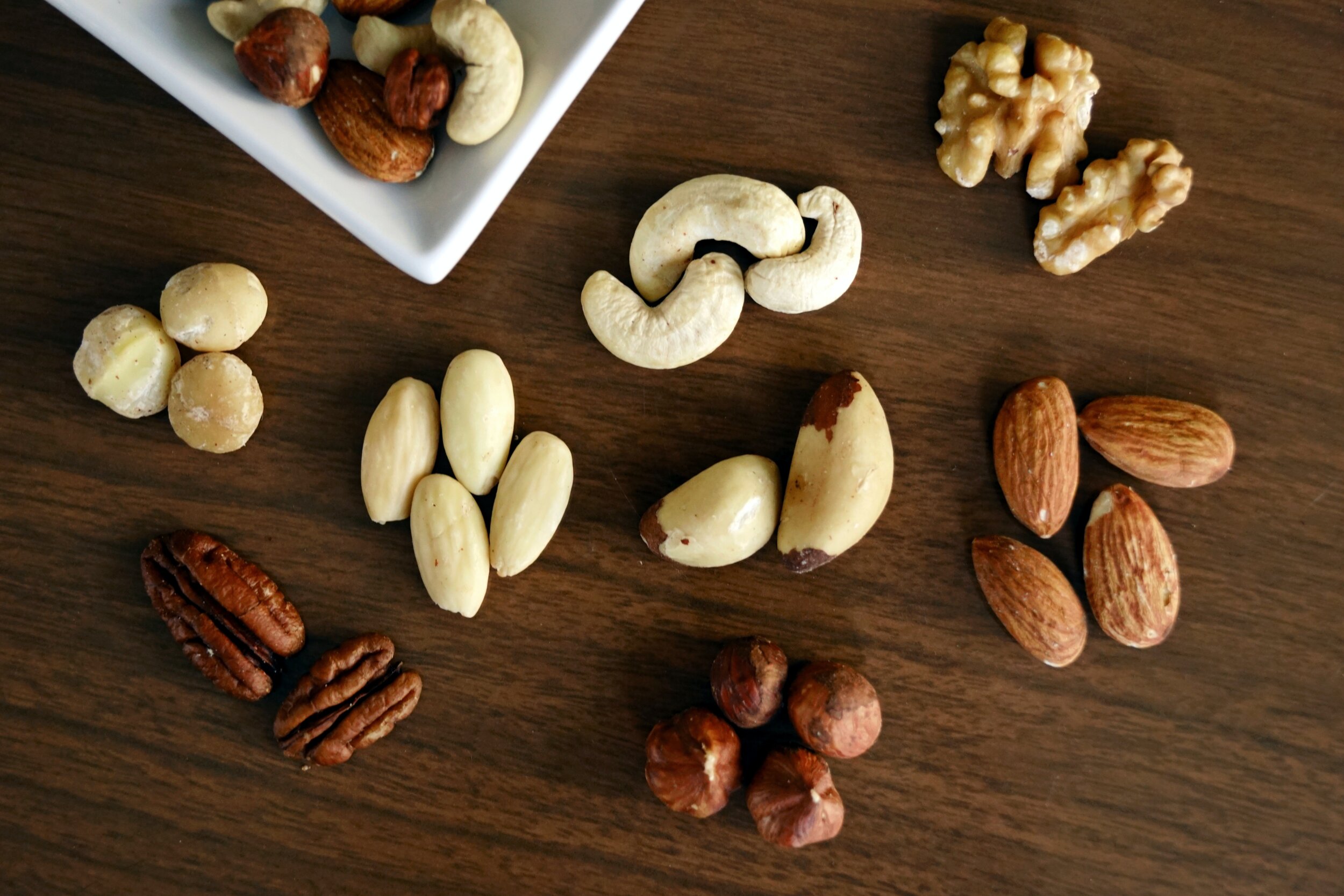 variety-of-brown-nuts-on-brown-wooden-panel-high-angle-photo-1295572.jpg
