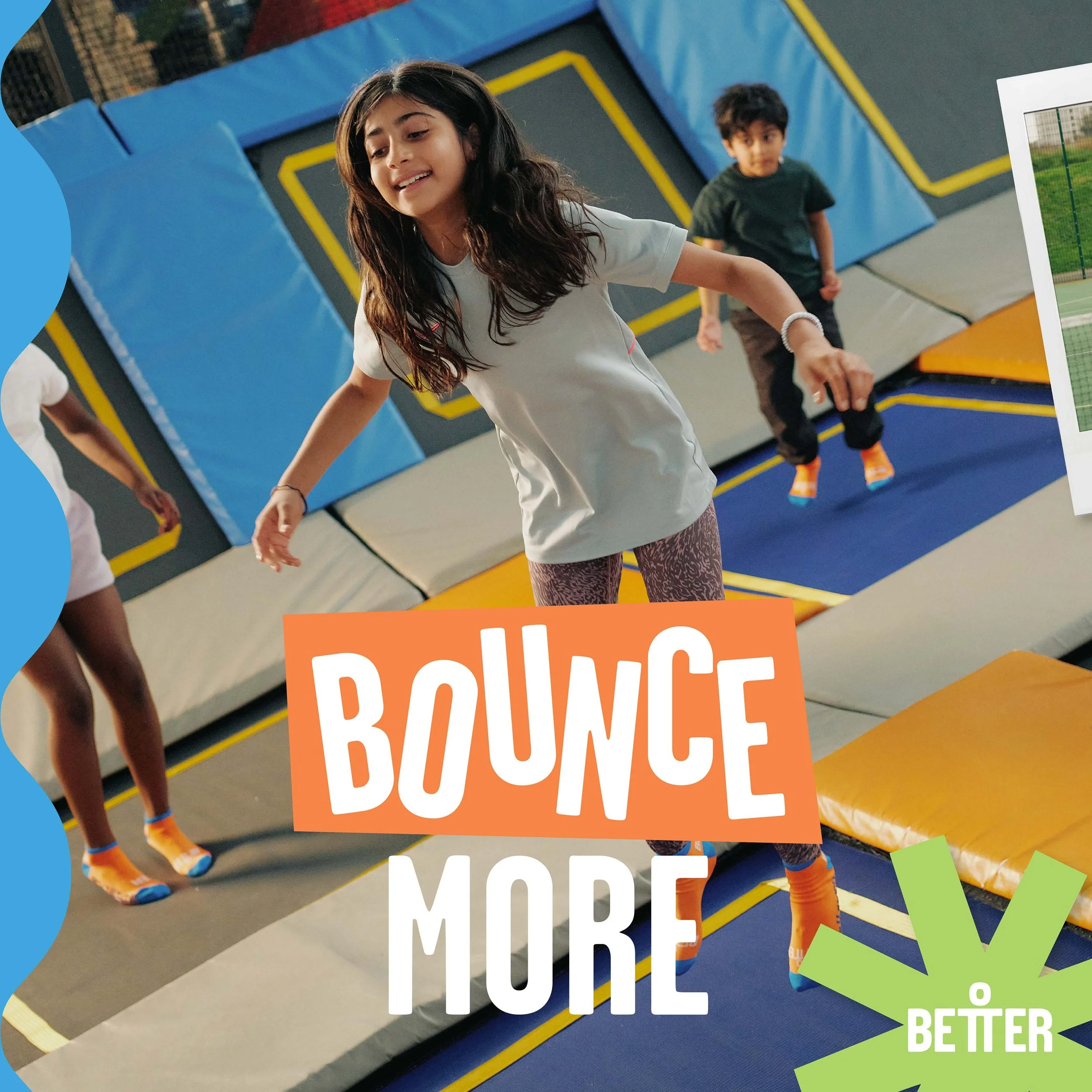 Children playing on an indoor trampoline park with a blue padded area and yellow boundary lines.