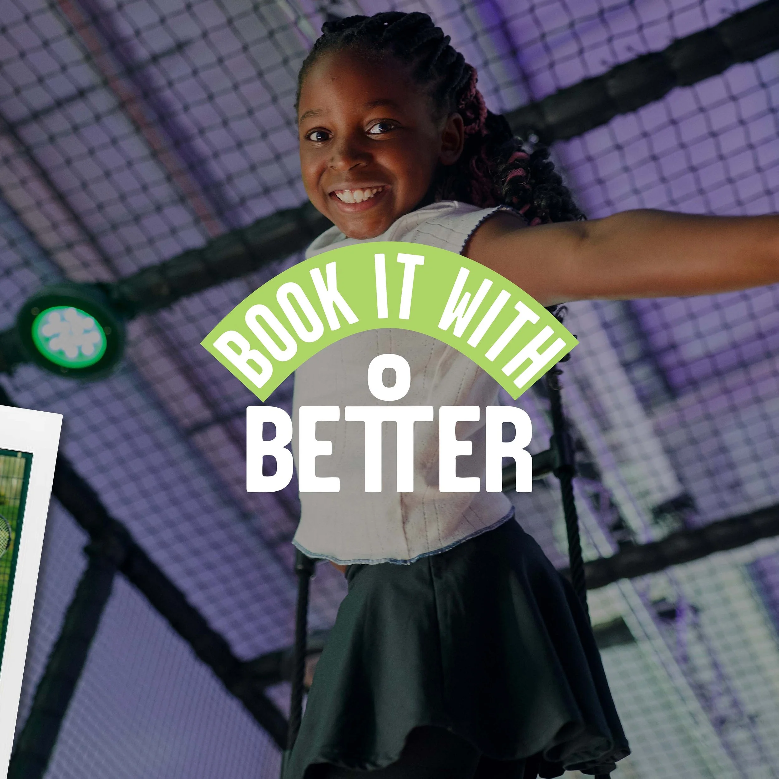 Smiling young girl with braids in a dance or gym setting, reaching upward with her arm, with purple lighting and a wire-mesh ceiling visible.