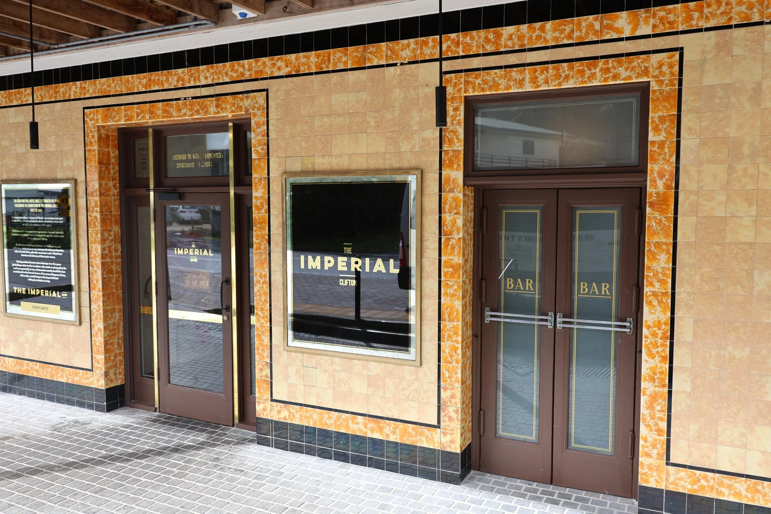 The restored orange and cream tiled facade and bar entrance of The Imperial Hotel Clifton