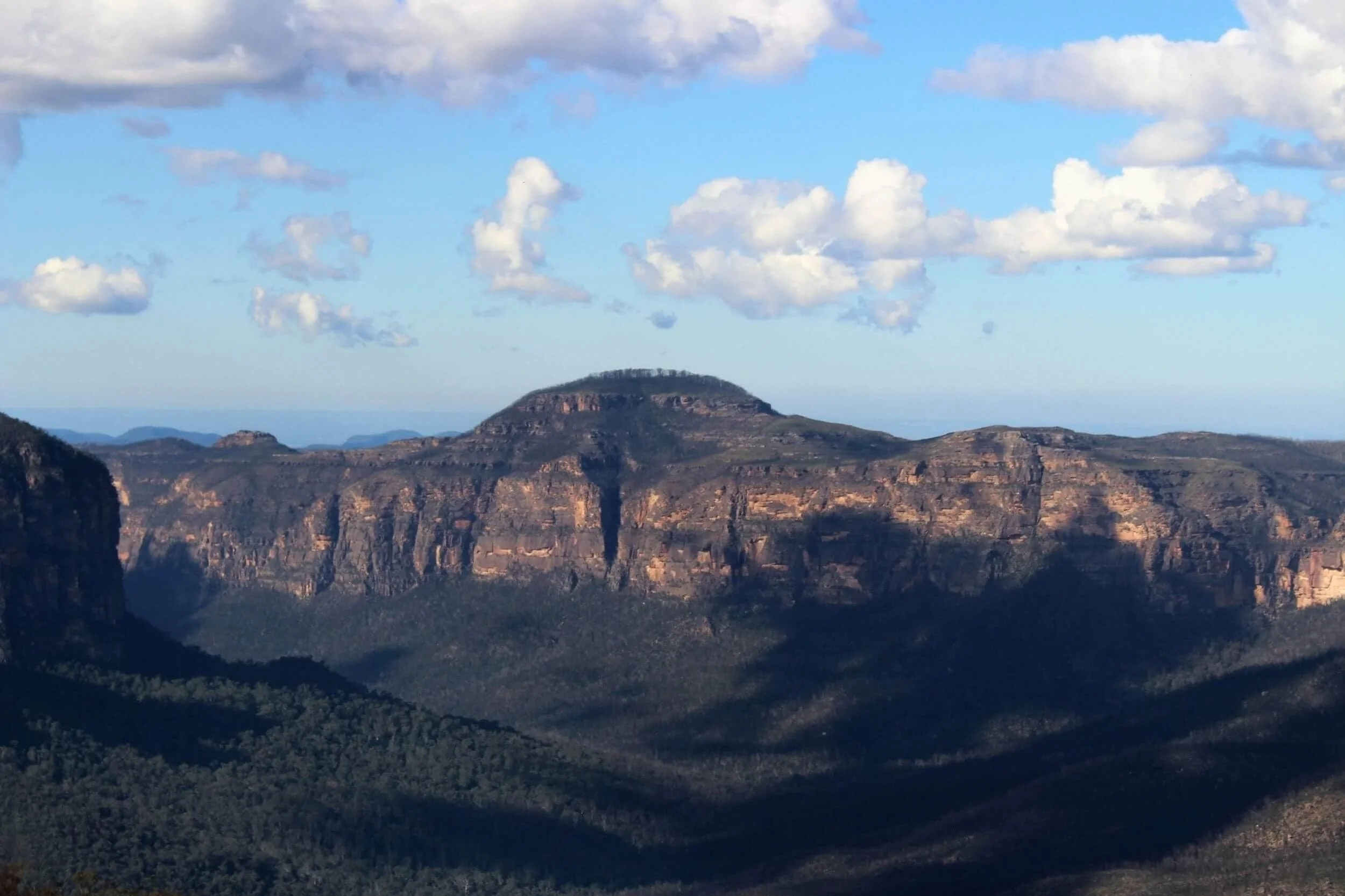 Sun and clouds are on display in a photo of Mt Hay later in the afternoon