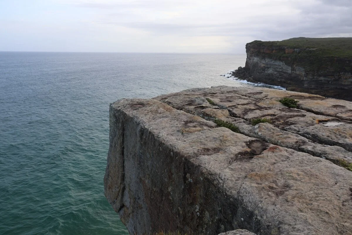 Eagle Rock sandstone overhang close-up showing flat top above the Pacific Ocean, Royal National Park