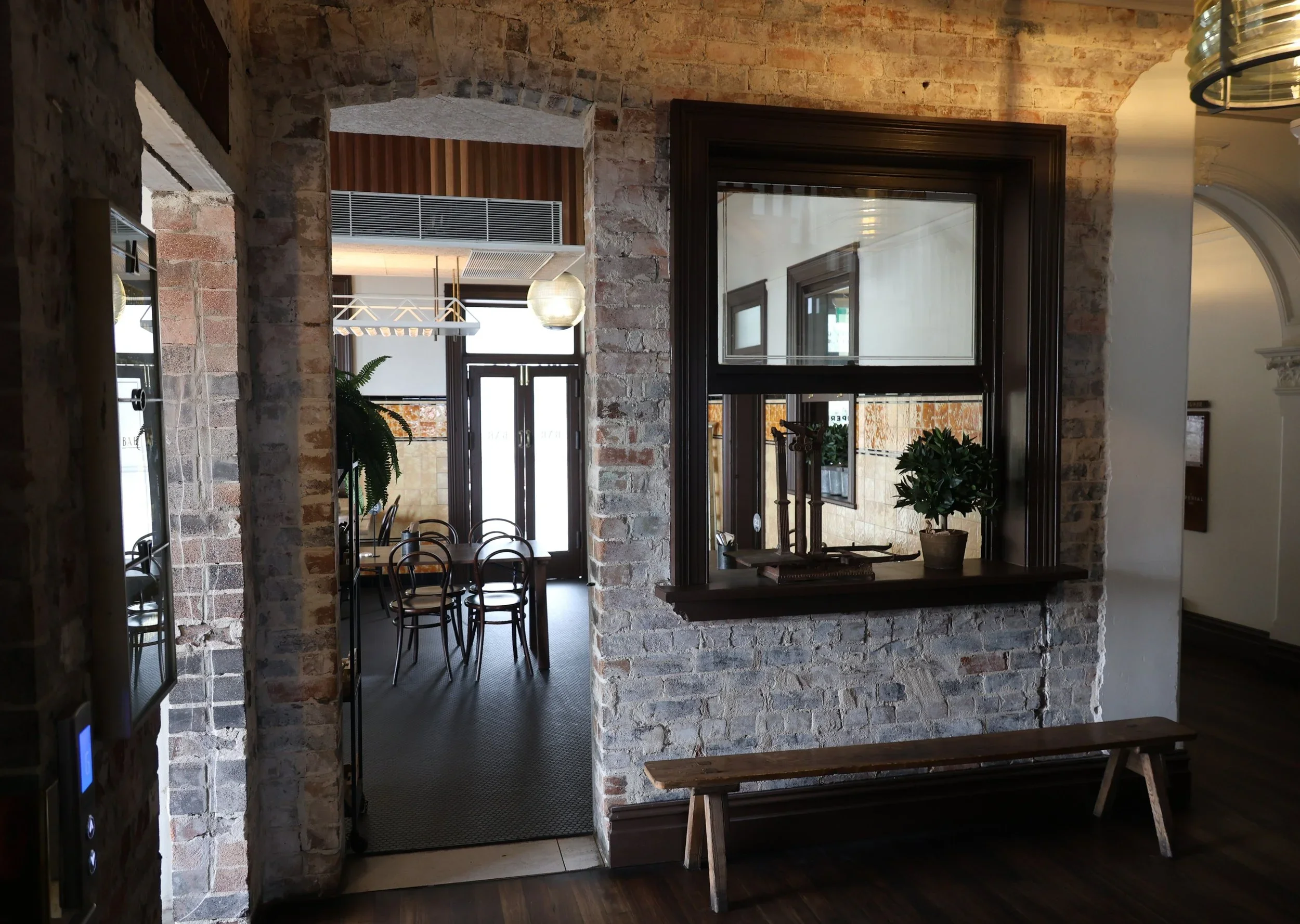 Interior foyer of The Imperial Hotel Clifton showing exposed brick archways and dining room