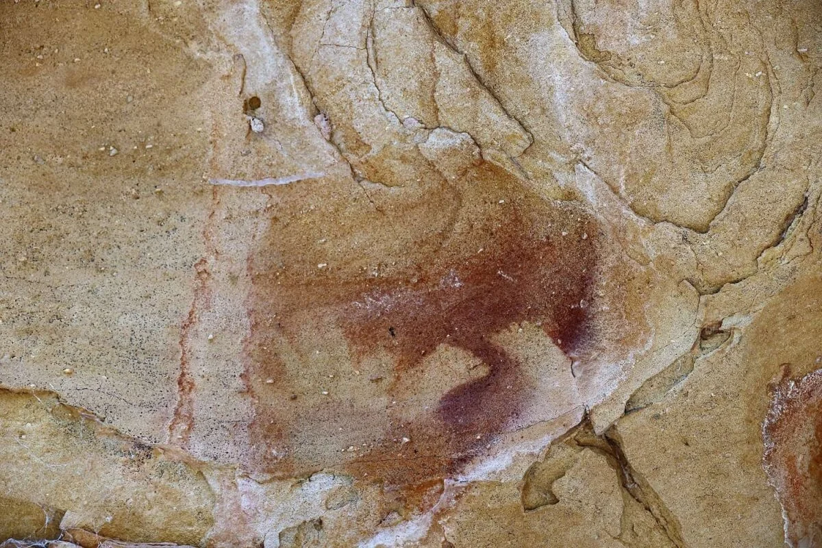 Ancient Wiradjuri hand stencil in ochre on sandstone rock face at Babyfoot Cave, Capertee region NSW