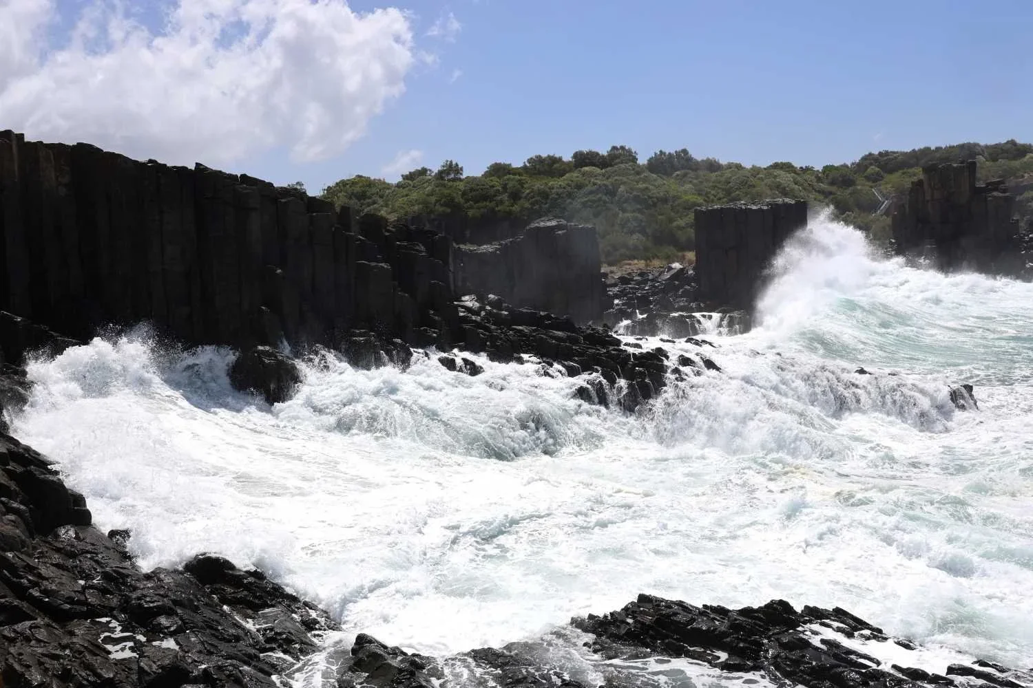 Waves surging against hexagonal basalt columns at Bombo Headland Quarry, Kiama, NSW South Coast