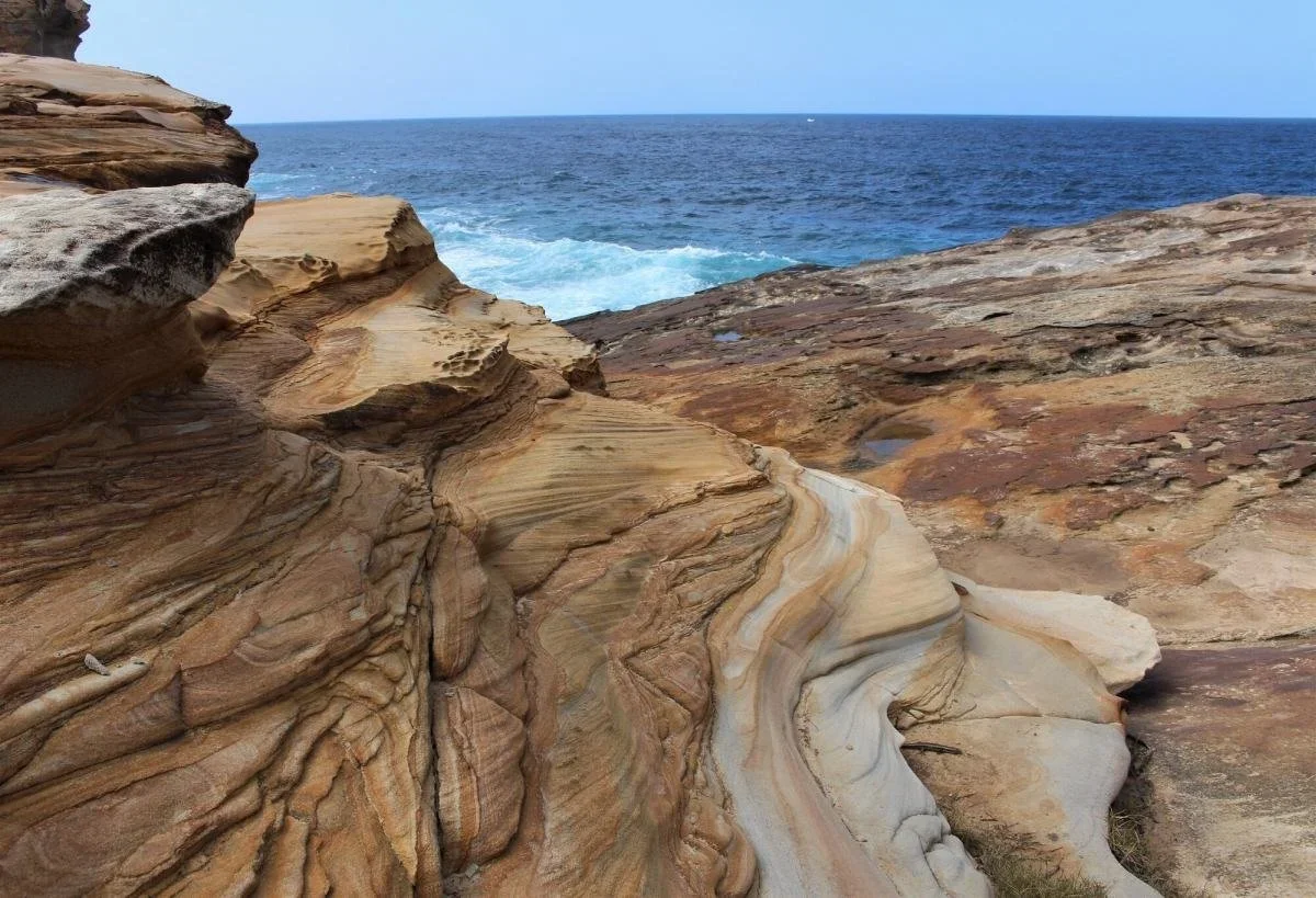 Yellow and orange layered sandstone at the Waterrun on the Wedding Cake Rock walk, Royal National Park