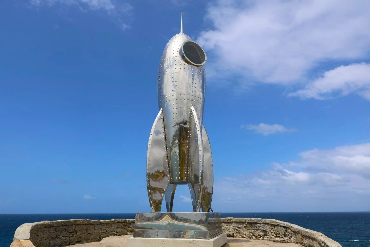 Eight metre stainless steel rocket ship sculpture above the ocean, Sculptures by the Sea Bondi 2024