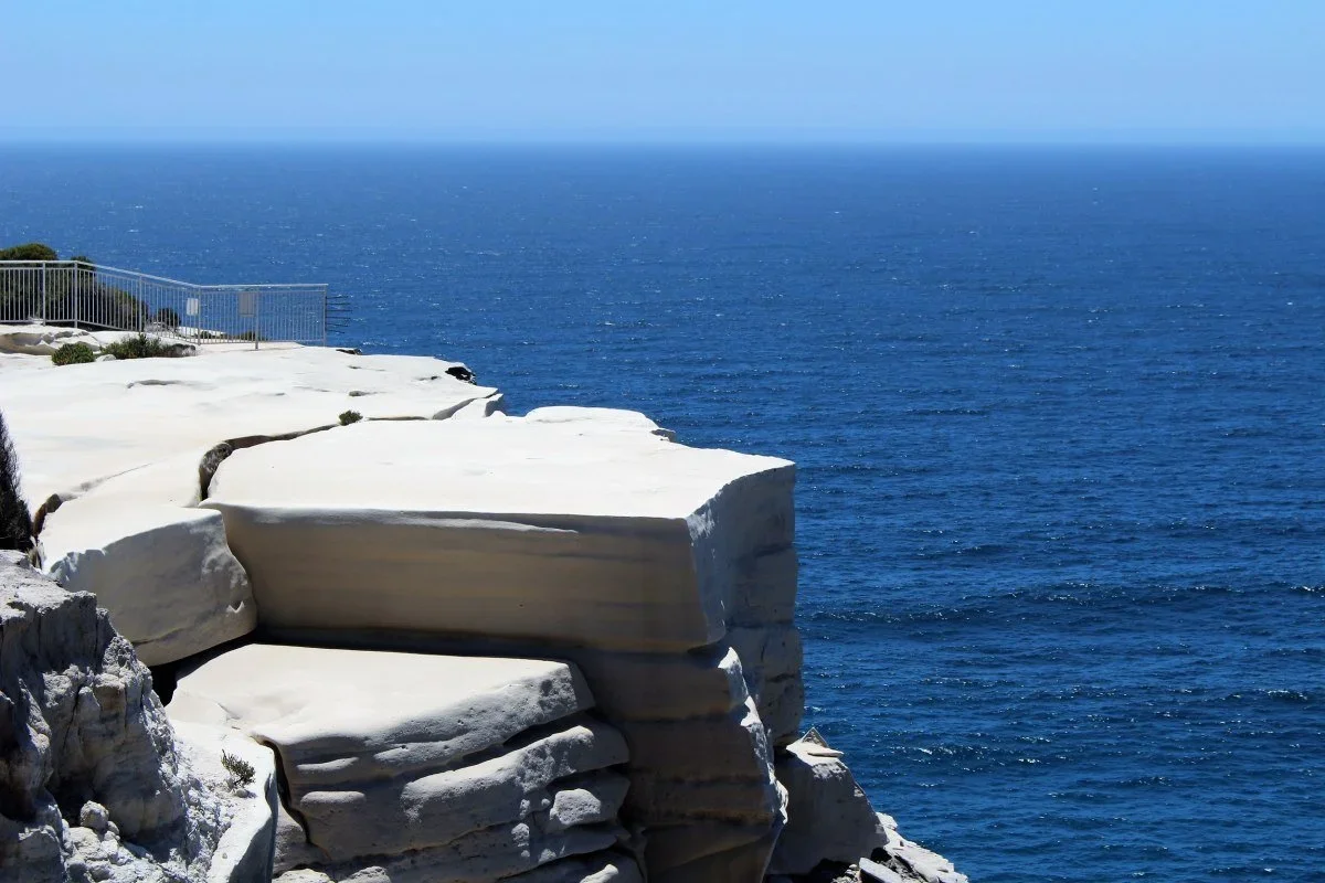 Wedding Cake Rock with safety fence, white sandstone platform above the Pacific Ocean, Royal National Park