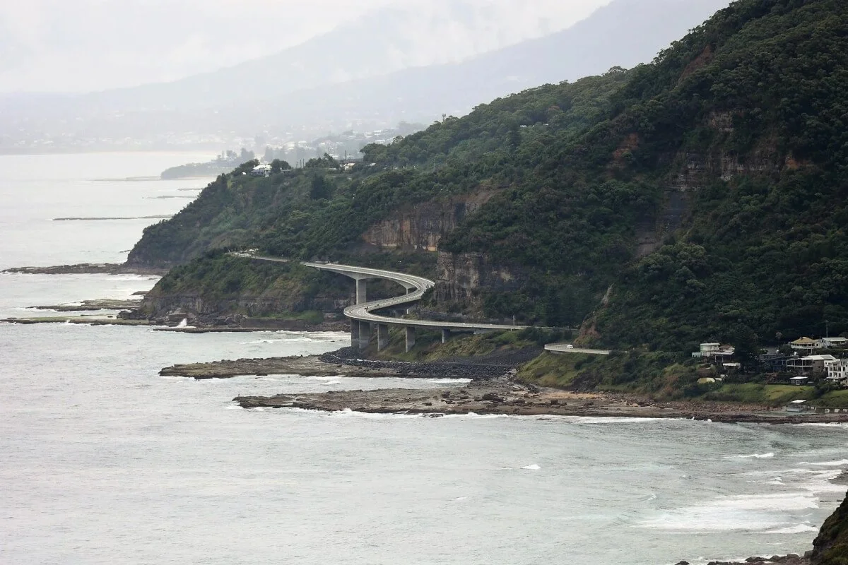 Sea Cliff Bridge curving along the NSW South Coast with Wollongong visible in the distance