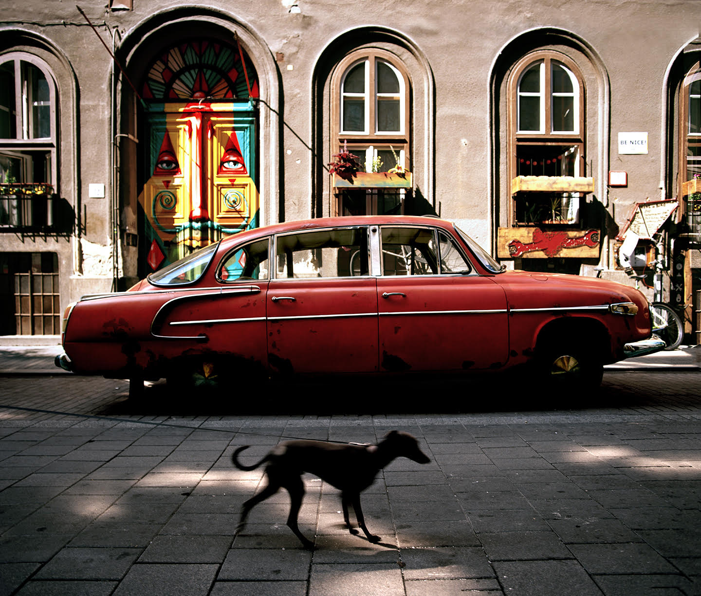 “So many of my favourite things are in this photo. From the wonderful styling of the vintage car, to the graffiti on the door, to the small plaque on the right reminding people to be nice. And to have a little whippet photo bombing me was the icing on the cake”