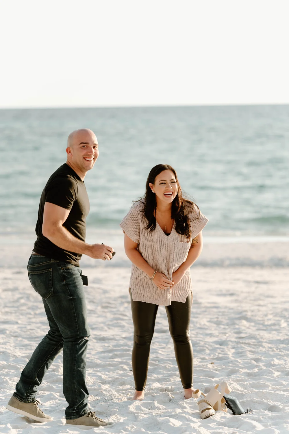  A happy couple smile big while standing on a beach during a 30A Proposal 