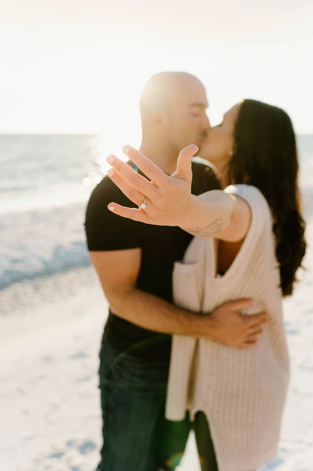  A woman shows off her ring after her 30A Proposal while kissing her fiancee 