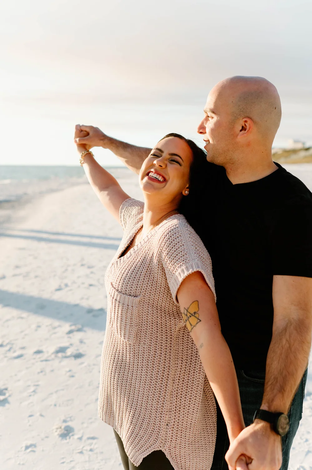  A happy couple dance on a beach at sunset during their 30A Proposal 