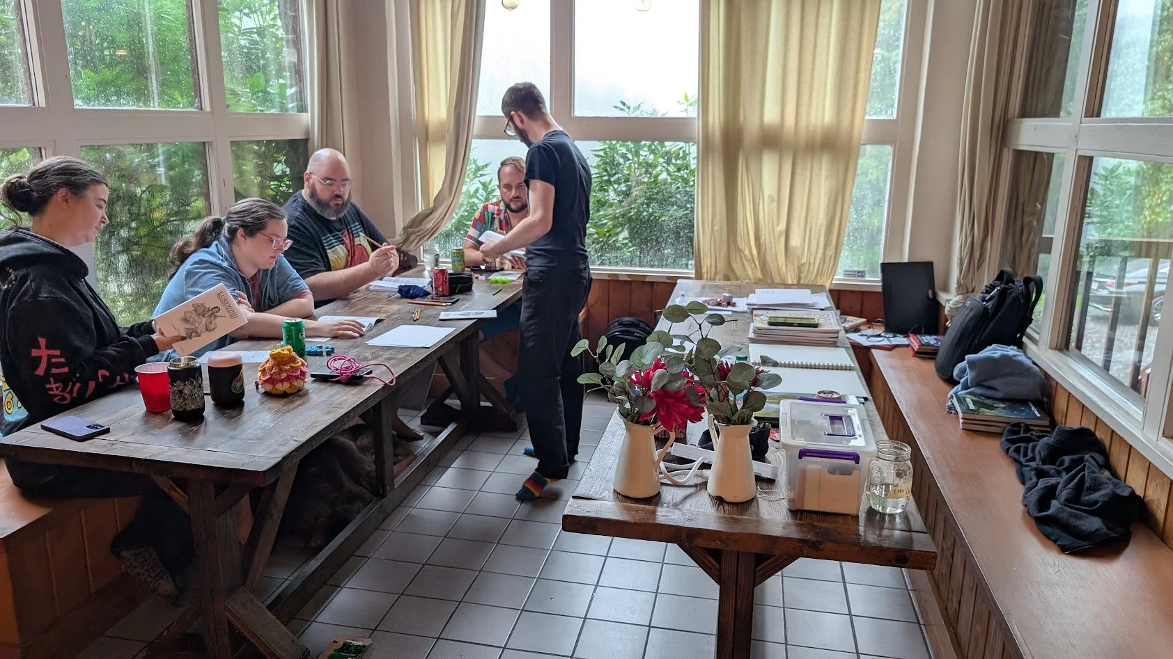 A photo of 5 people playing my ttrpg game lorewind.