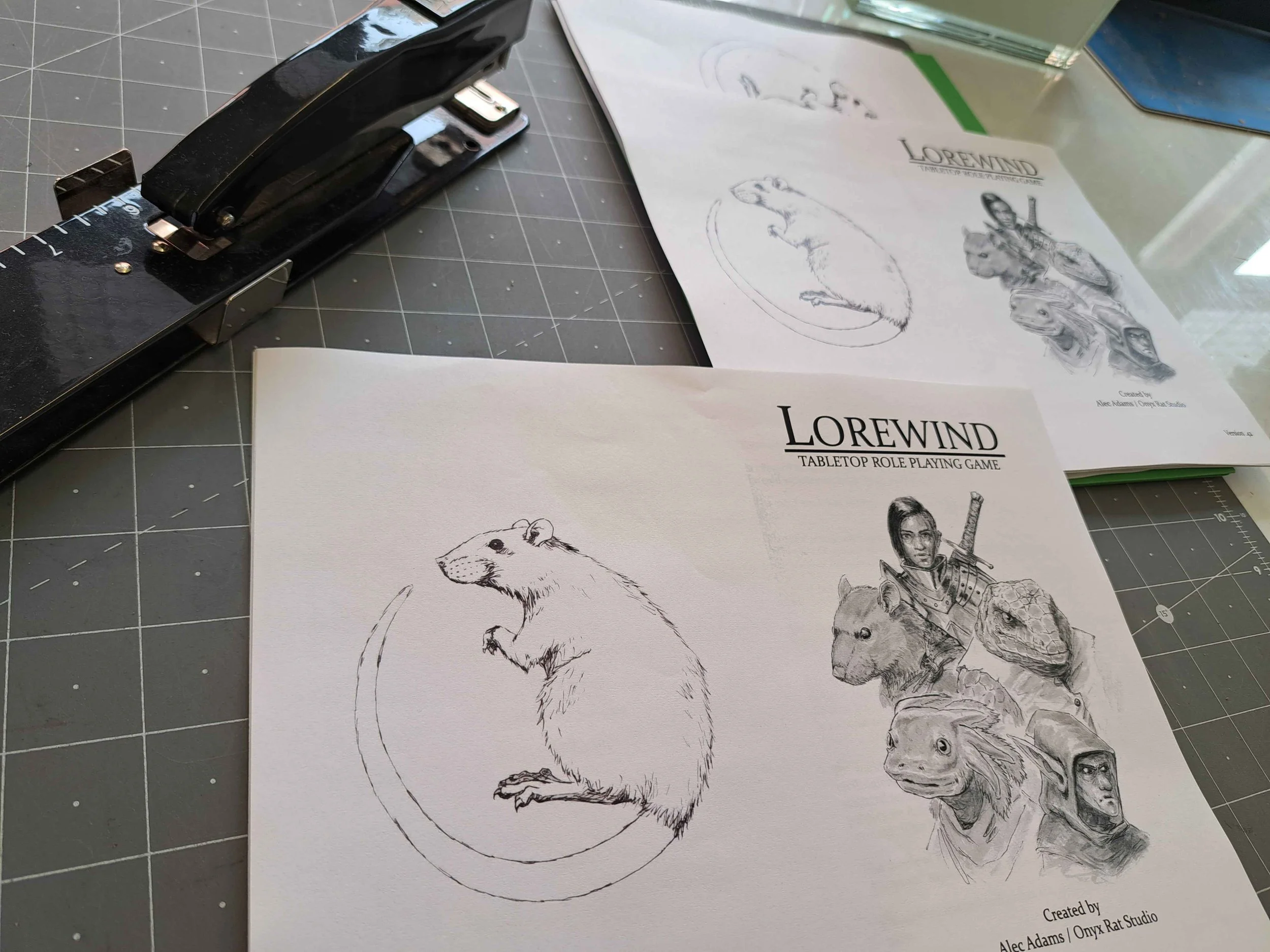 A photo of a table with a long arm stapler and a booklet for my game lorewind being assembled.