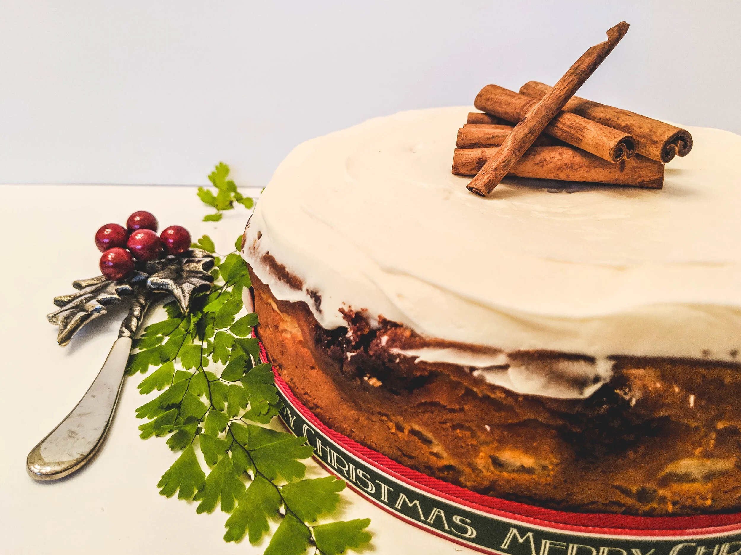 cinnamon roll cheesecake whole side with greenery.jpg