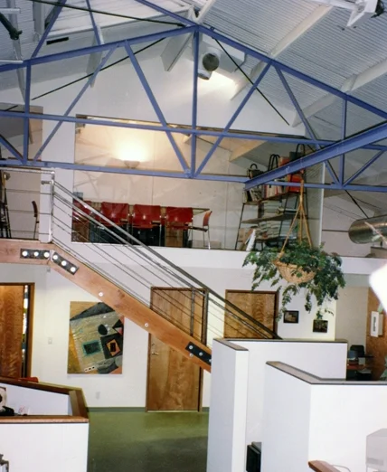 Glass-front mezzanine conference room allows for acoustical privacy in open space. Painting by Roxane Berger.