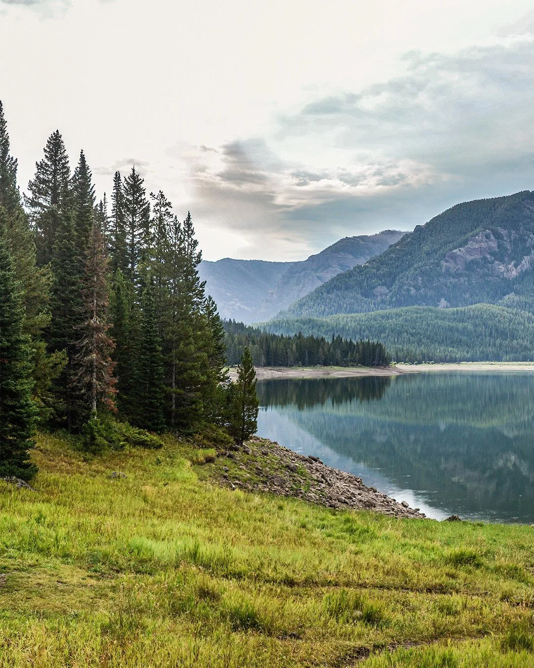 A quiet morning at camp along the lake in August.  It&rsquo;s hard to beat these quiet, calm, and still mornings when the lake looks like glass and you can really just soak in the mountains!  #camping #campinglife #mountainlake #exploremontana #camps