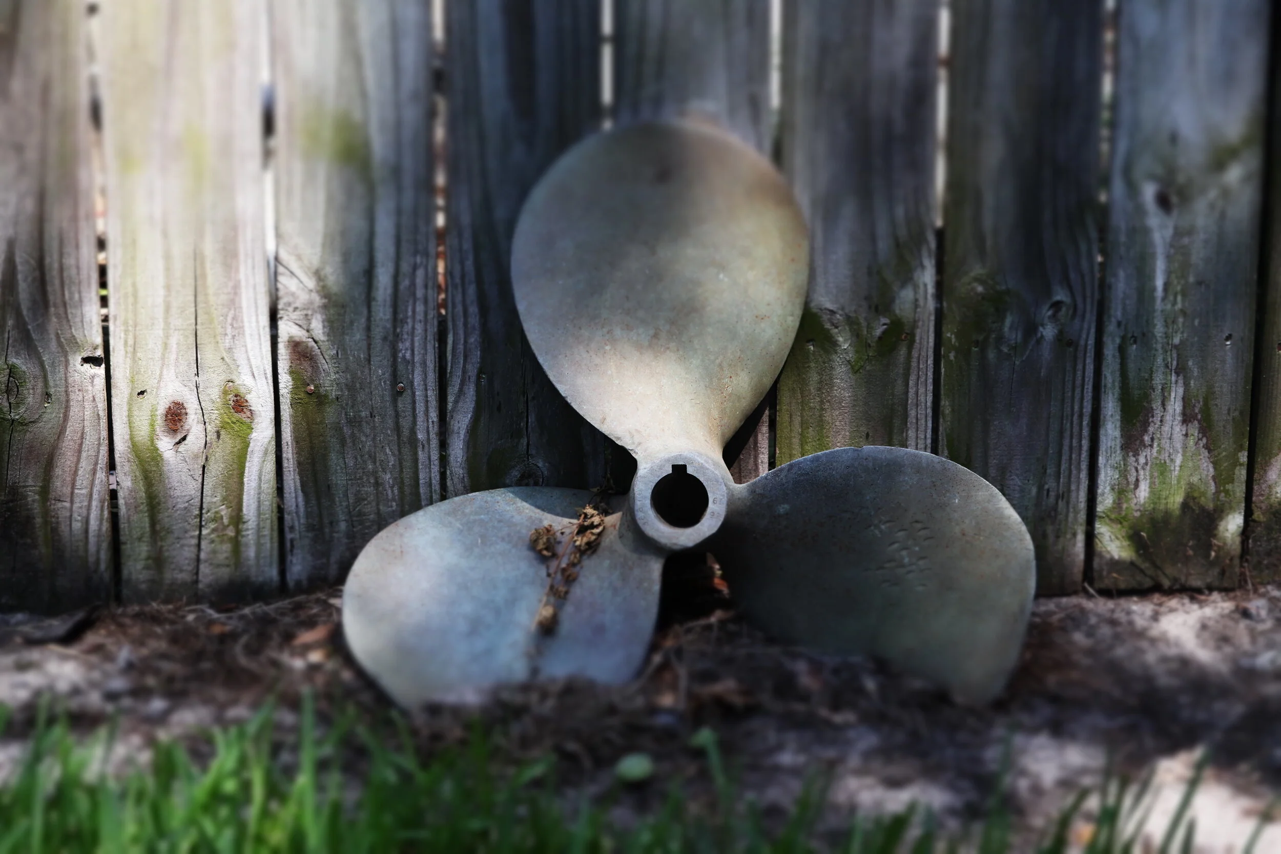 Old Boat Propeller Against an Aging Fence