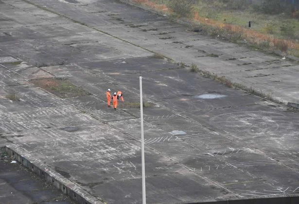 Three workers inspecting the future HS2 site off Curzon Street (Image: Darren Quinton / Birmingham Live)