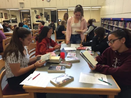 Ms. Smetana’s students exploring different titles in their “Speed Dating” book search.