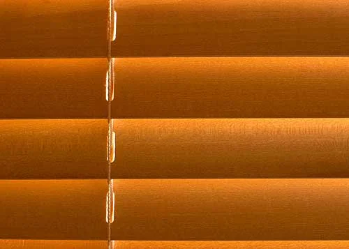 As the light bounces between these wooden slats the colour of the wood is enhanced by the fact that light of the same colour is reflecting back onto it. The result is that the coloured light and the underlying surface combine to create a glowing and saturated version of the wood's existing colour.