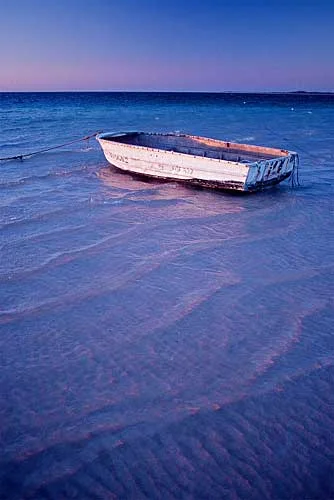 Here the very delicate dusk skylight is reflecting pink and blue from the water and the boat.