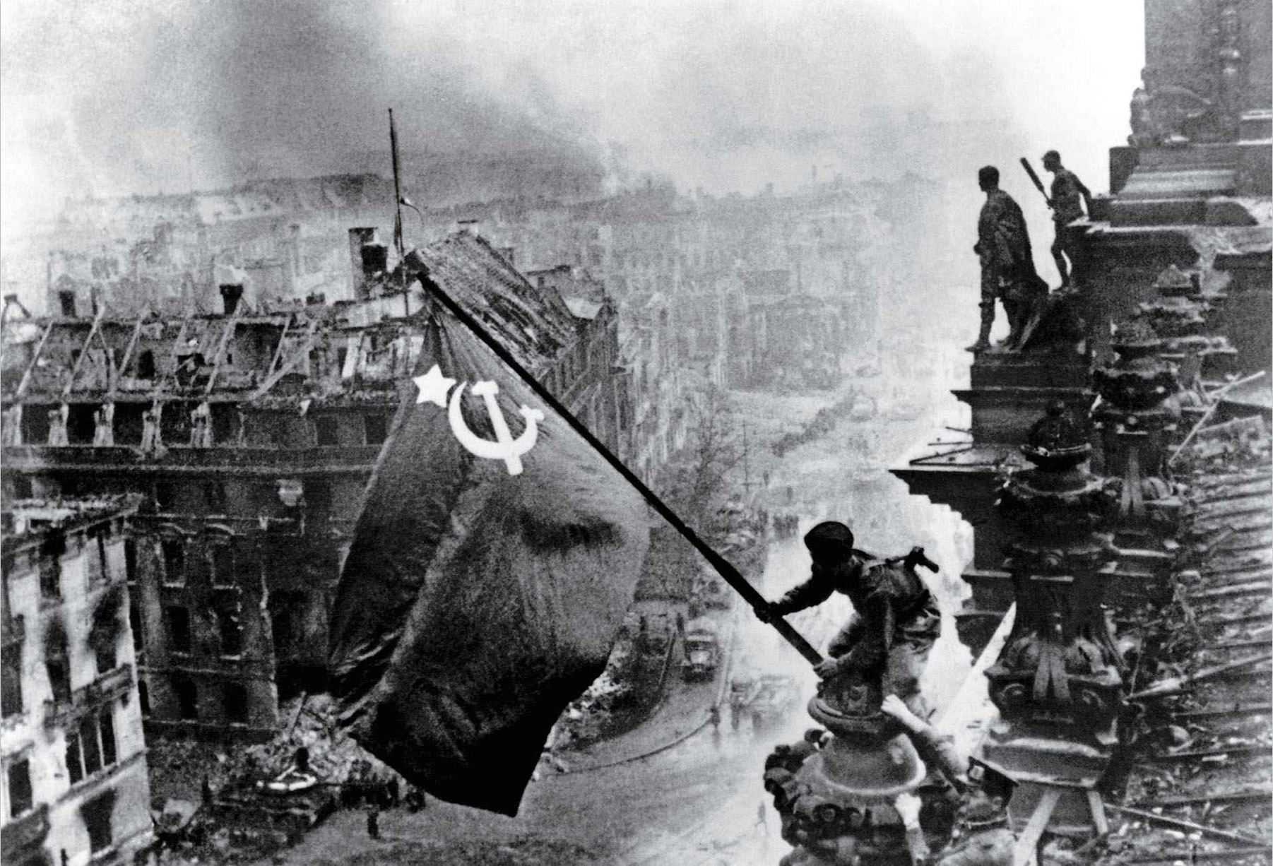 Raising a Flag over the Reichstag by Yevgeny Khaldei (1945)