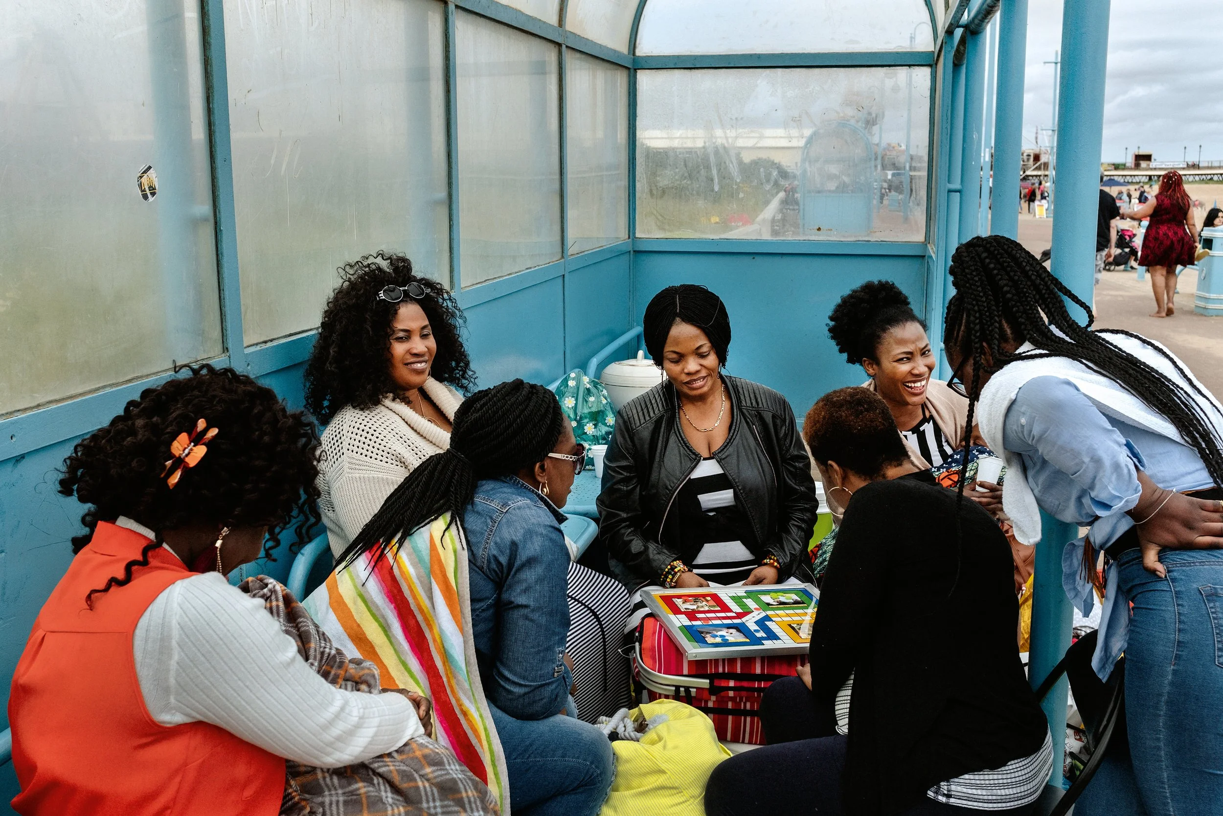 Ladies playing a board game in a shelter by the seaside, Skegness, July 2019.jpg