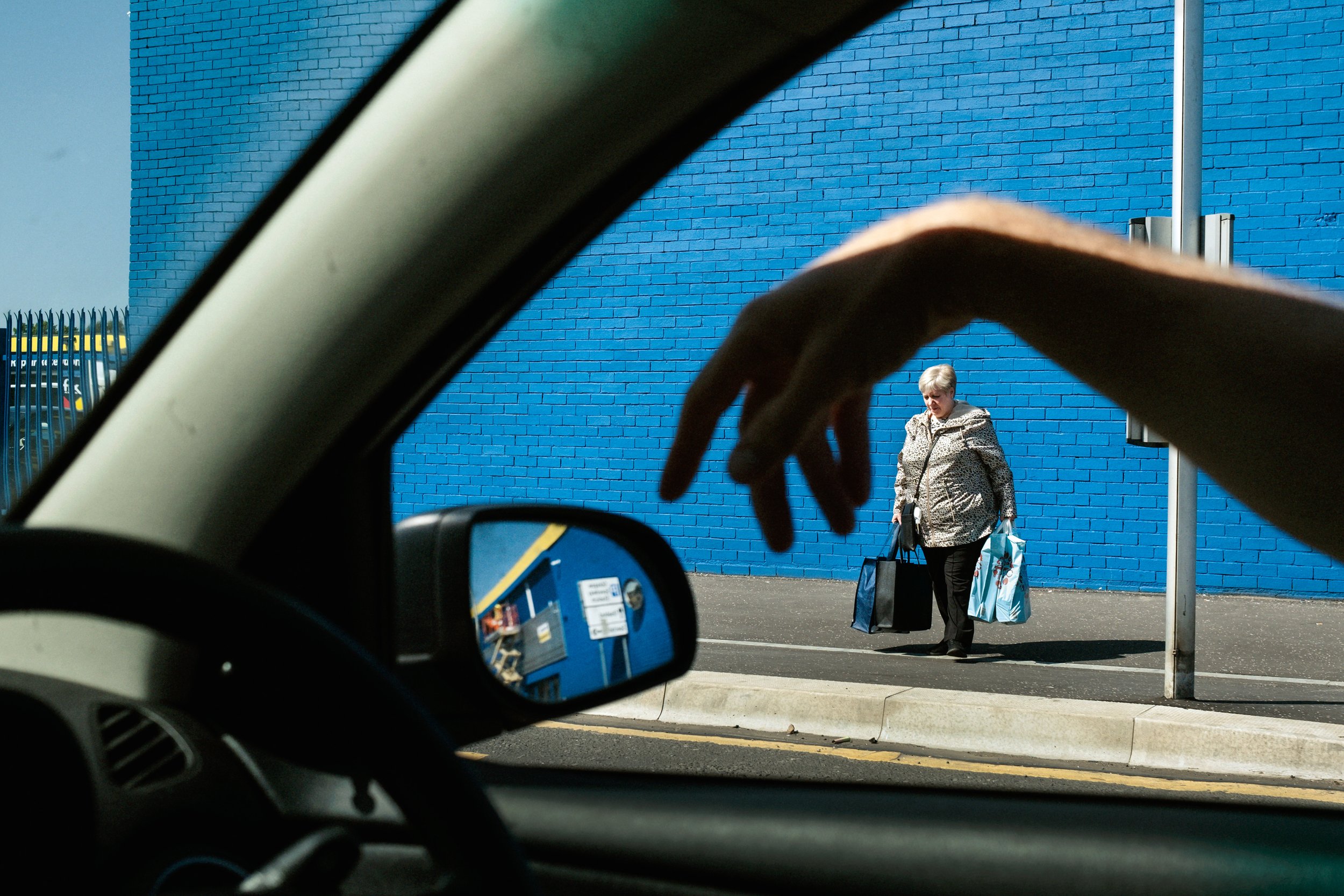 The driver’s hand as he points out where he grew up in Glasgow, May 2023.jpg