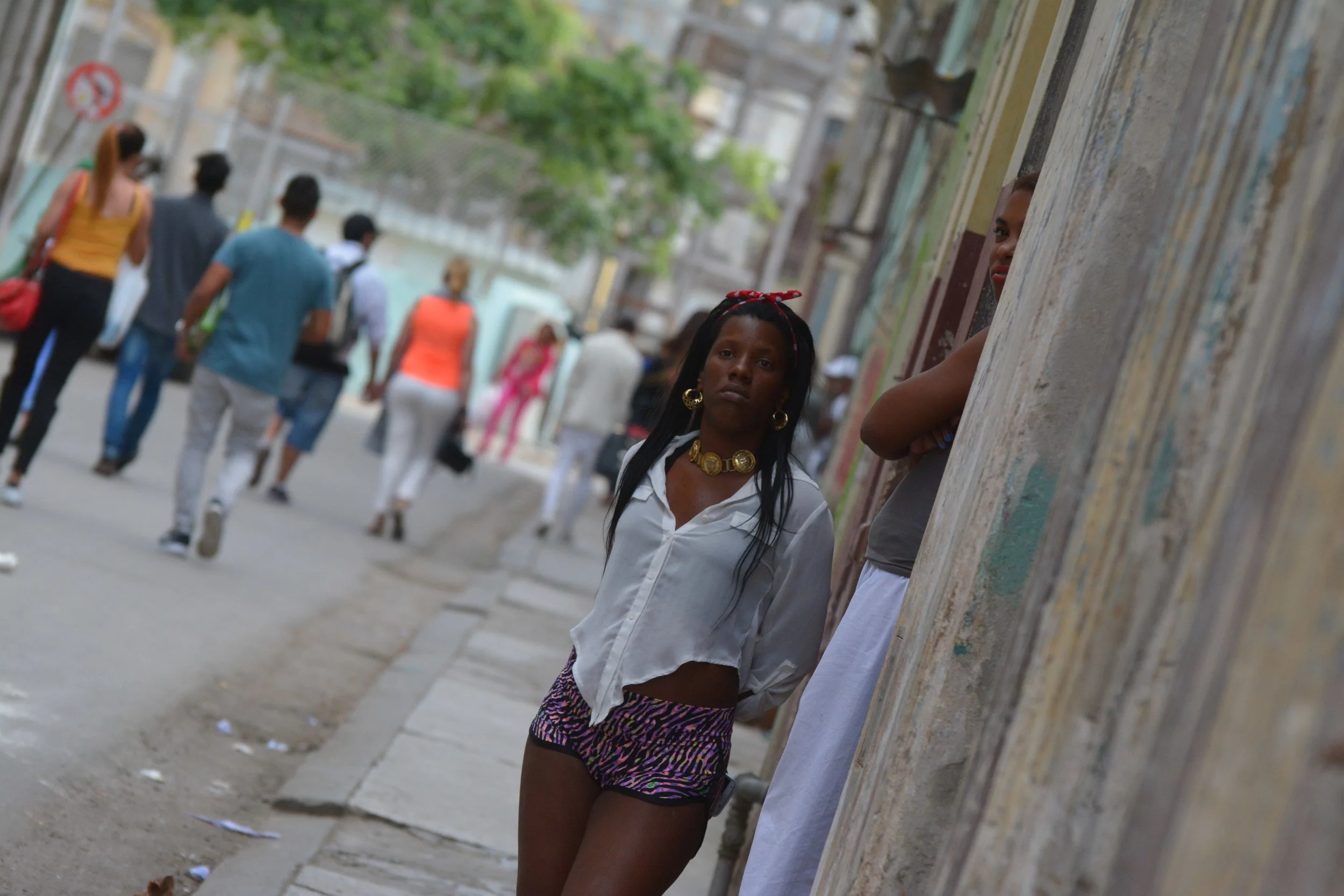 Young woman standing in front of house in old Havana