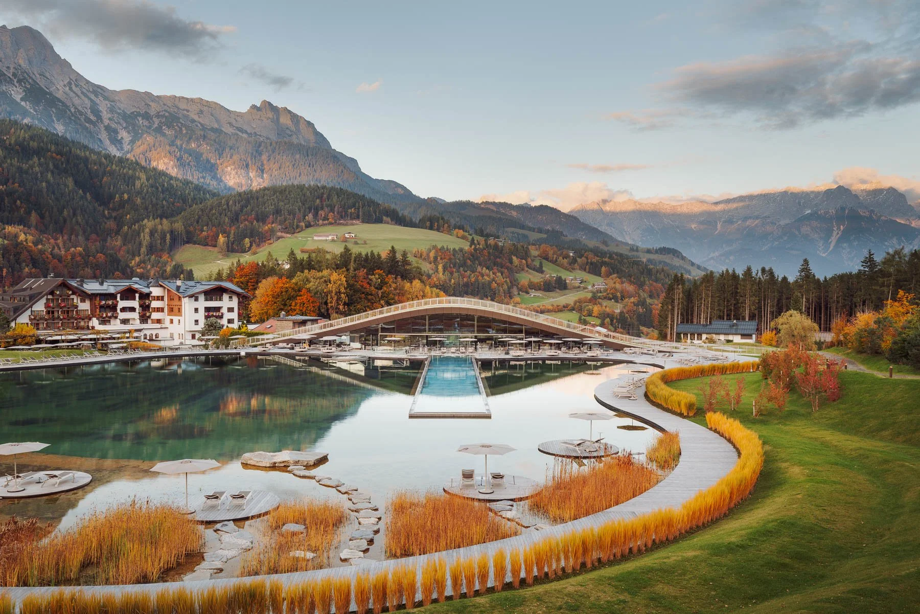 Design spa interior with 50 metre infinity pool at sunset during autumn.