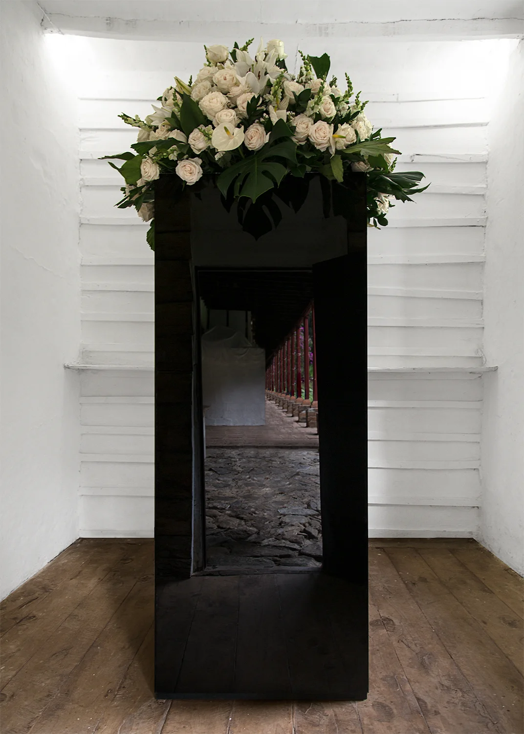 "Funerary Monument for the Viewer" pine wood, nails, black mirrors, flowers 3 ft. wide x 9 ft. tall x 3 ft. deep 2016