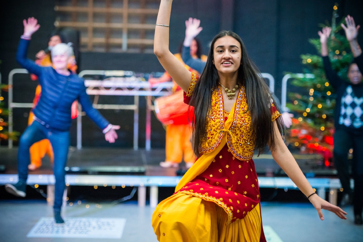 One of Parv Kaur’s dancers shows the crowd what to do at the Festival of Masters - image by Dee Patel