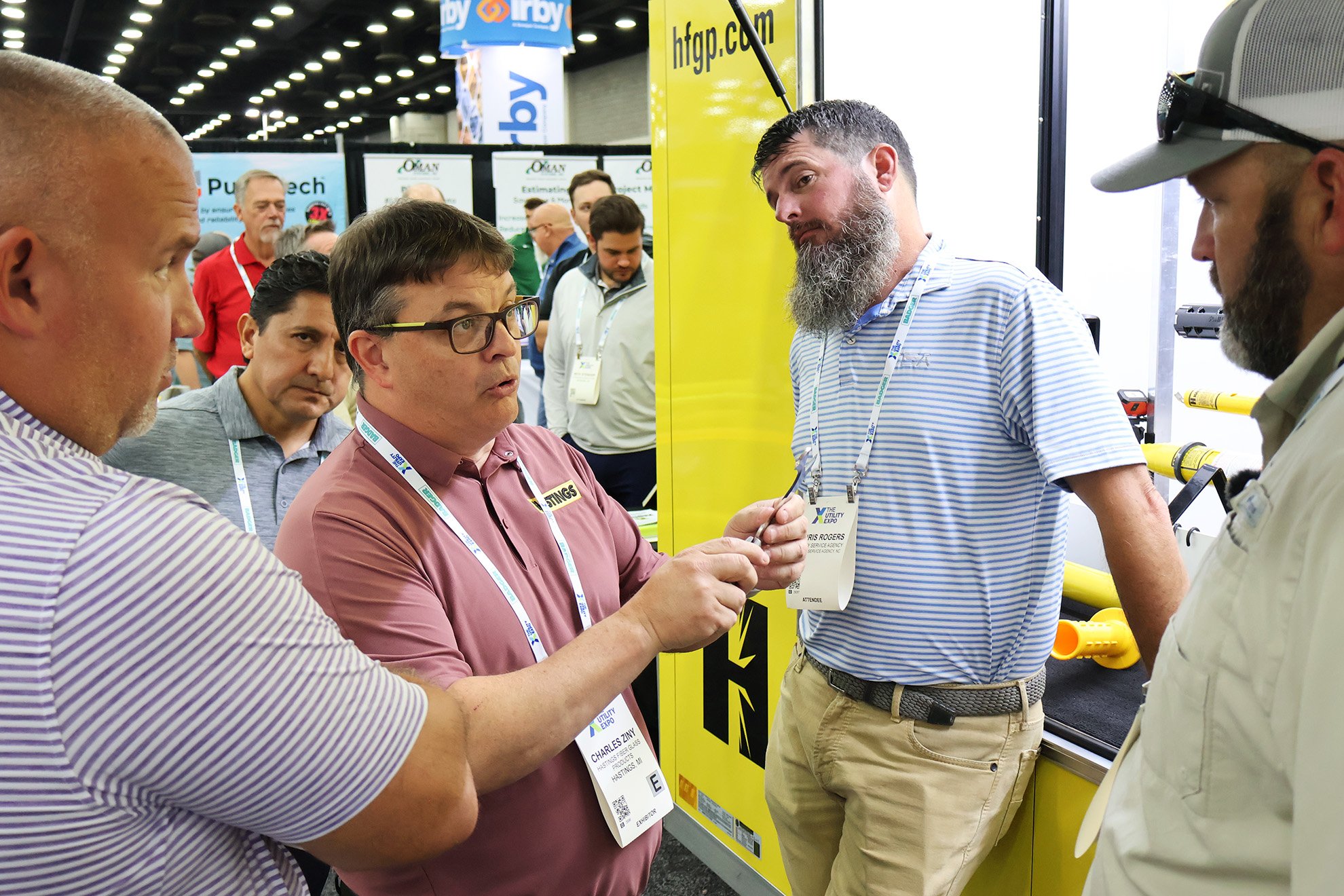 Territory Managers Chris Rogers, Chris Rush, and Ryan Keitel meet with a Hastings representative to discuss a new product at the Hastings booth during Utility Expo 2025.