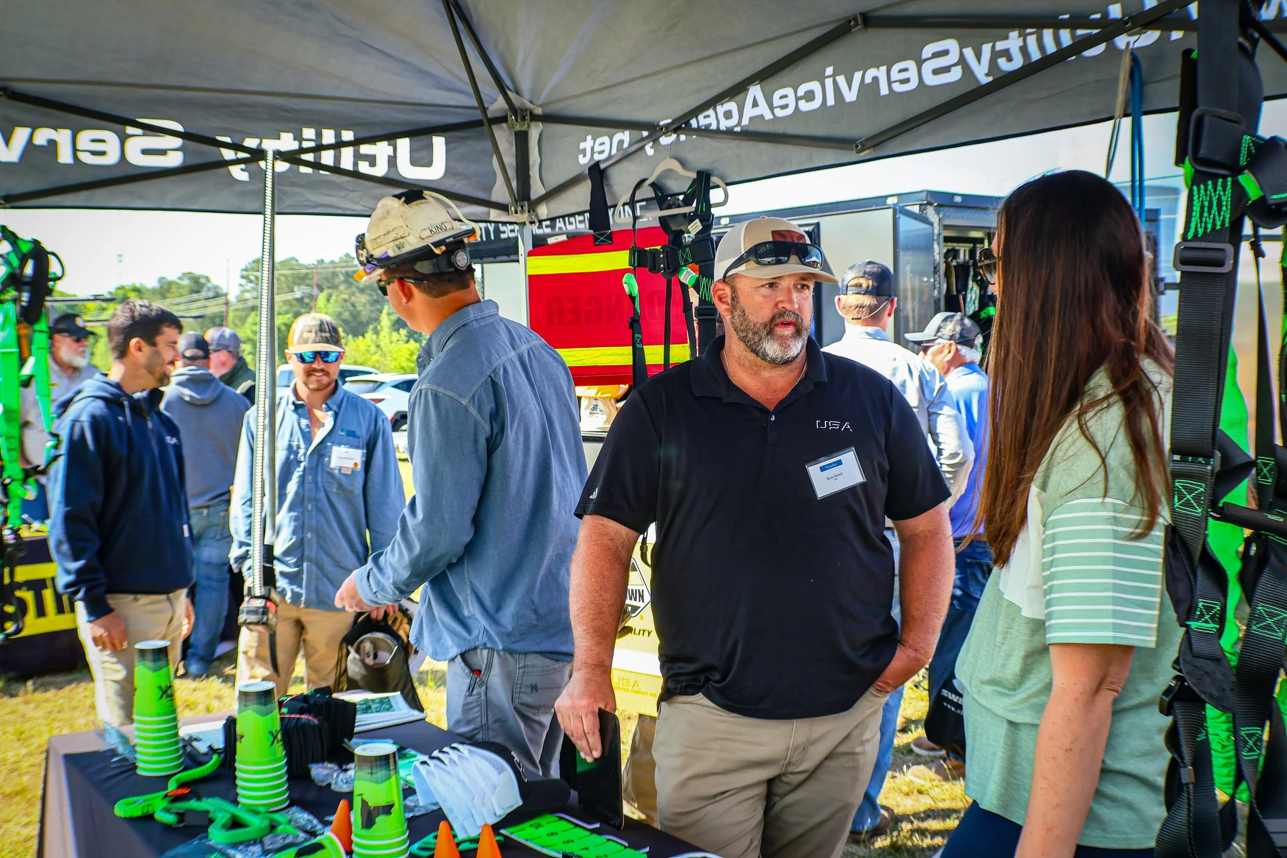 Territory Manager Ryan Keitel speaks with a customer at the USA booth during Duke Energy's Transmission Line Safety Day event