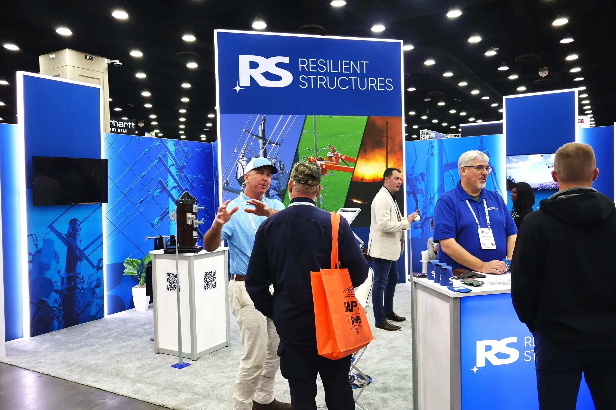 Territory Manager Mike Pridmore in deep conversation with a customer at the Resilient Structures booth of the Utility Expo 2025