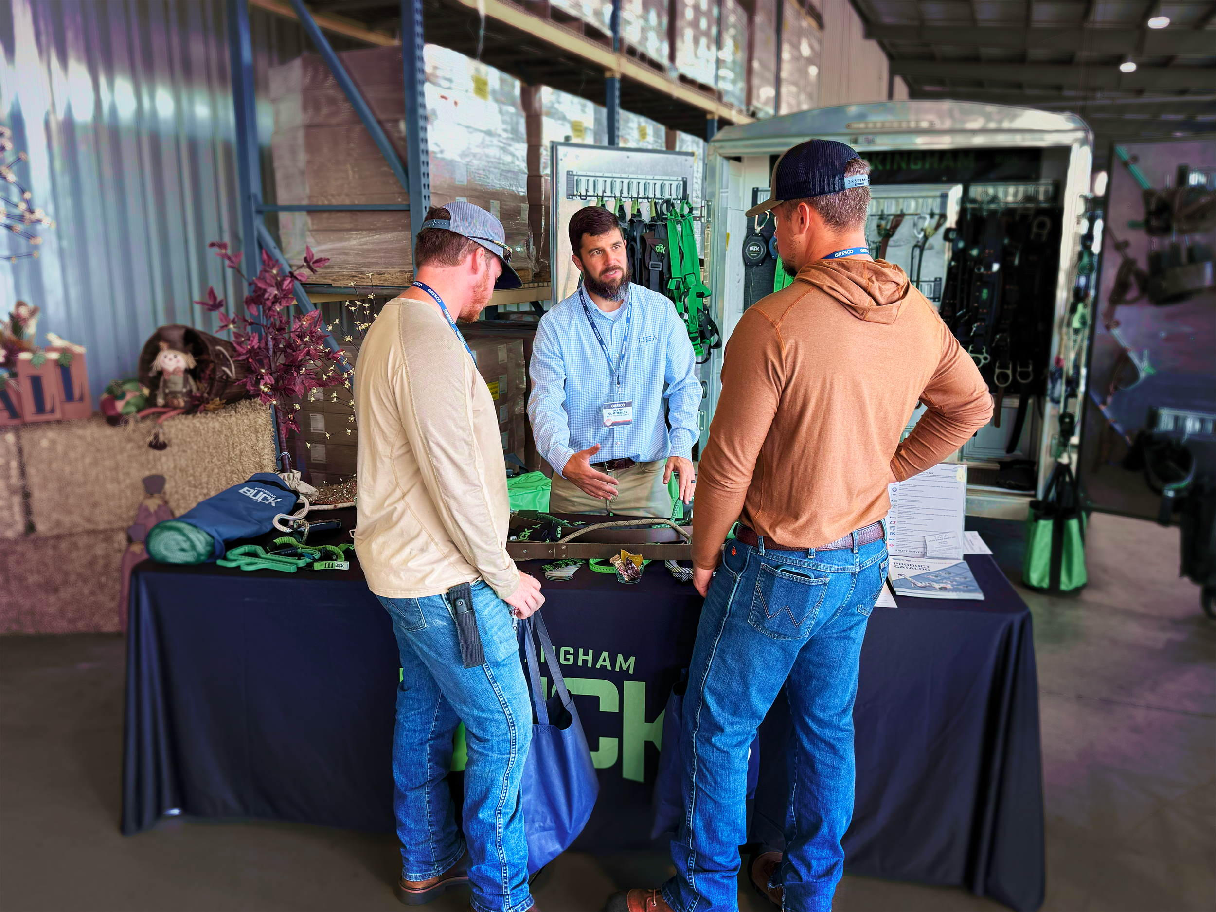 Wade Summerlin discusses Buckingham products with two customers at Gresco's Fall Festival in 2024