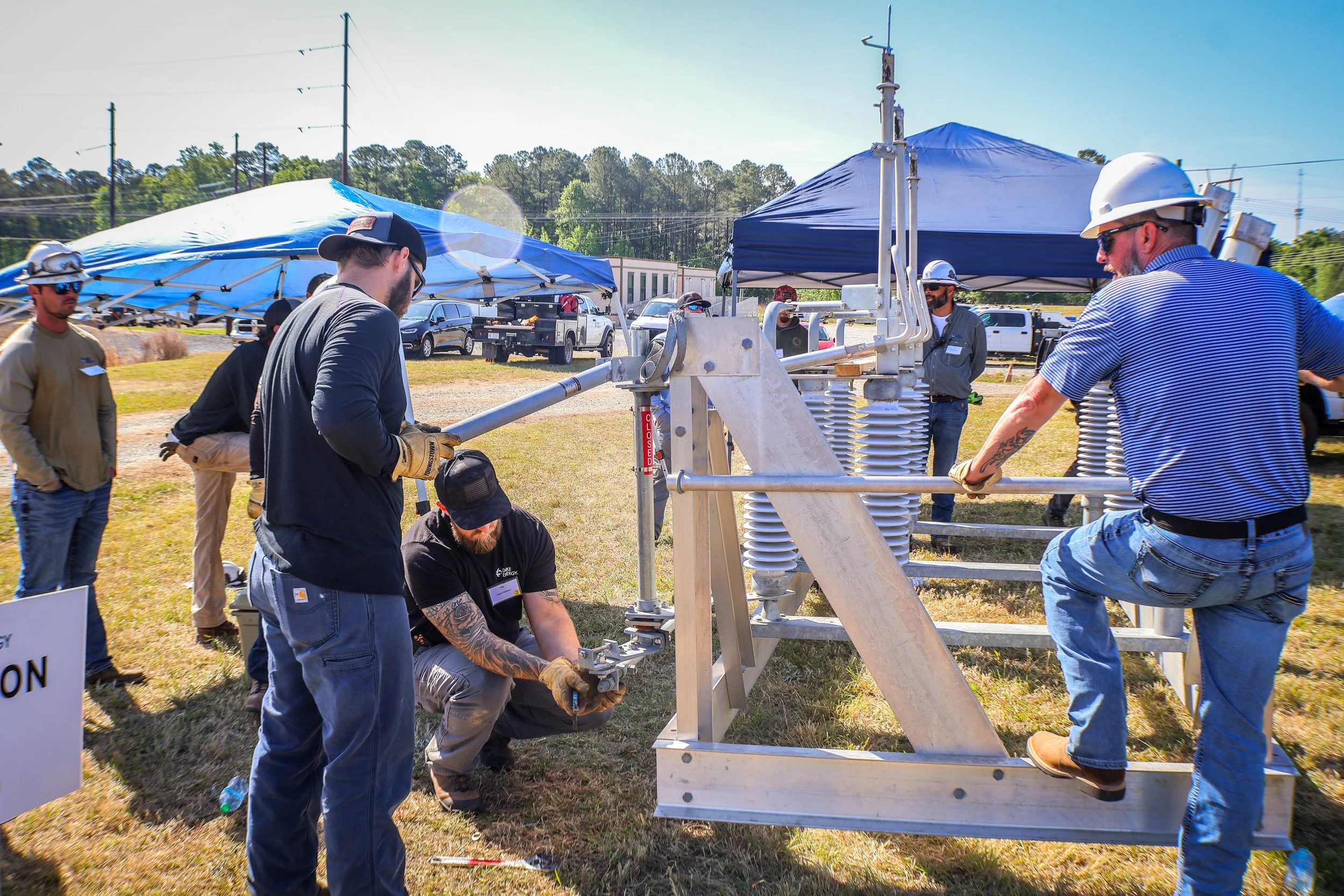 Chris Rogers (on right), Territory Manager, leads a training on the operation of Cleaveland/Price switchgear at Duke Energy's Transmission Line Safety Day event