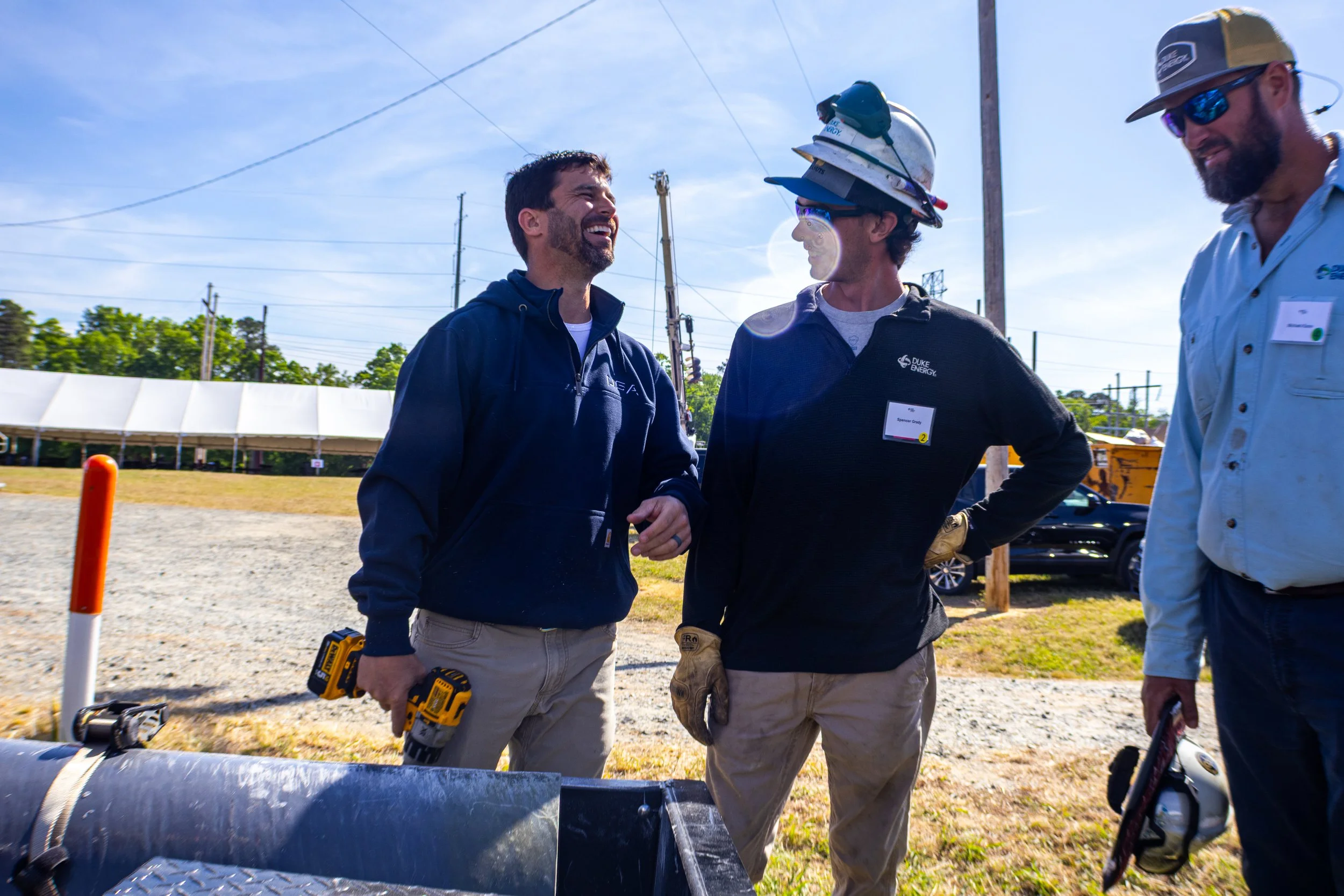 Vice President Wade Summerlin shares a laugh with a lineman during a demonstration at Duke Energy's Transmission Line Safety Day event