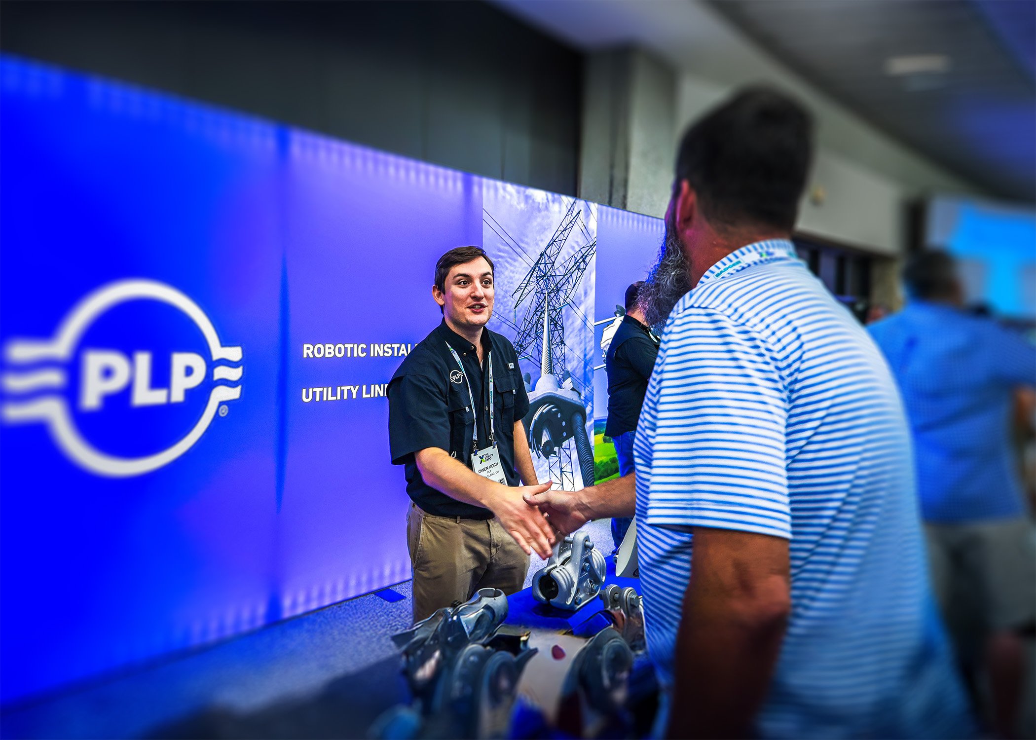 Territory Manager Chris Rogers shakes the hand of a PLP representative at the Utility Expo 2025.