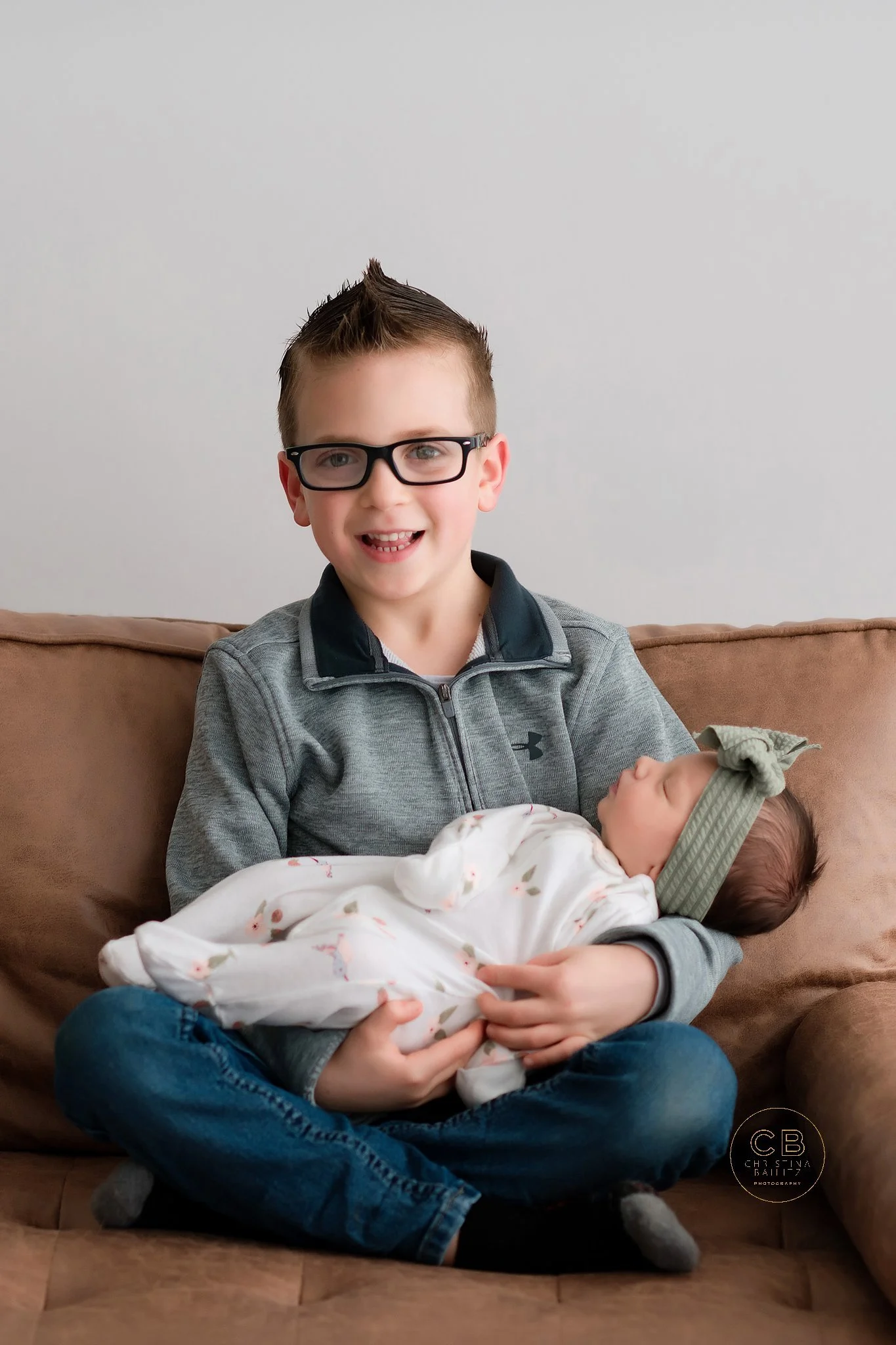 studio newborn session - sibling holding baby.jpg