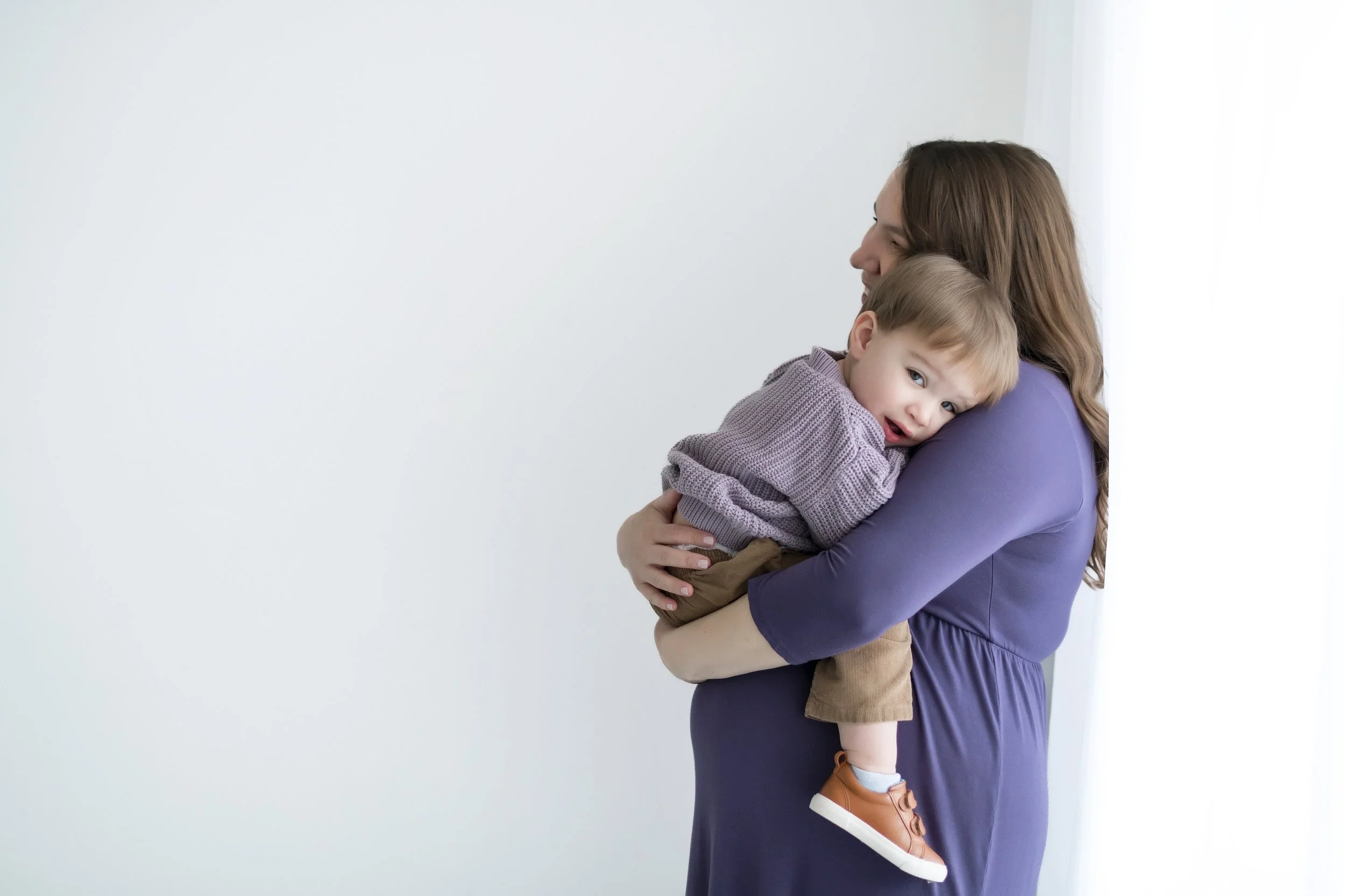 Maternity moment with toddler in studio photo session.jpg