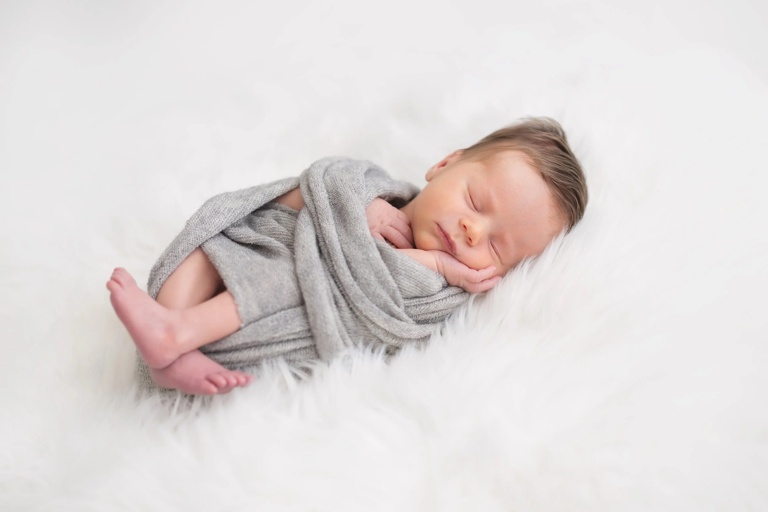 Posed newborn baby boy studio session