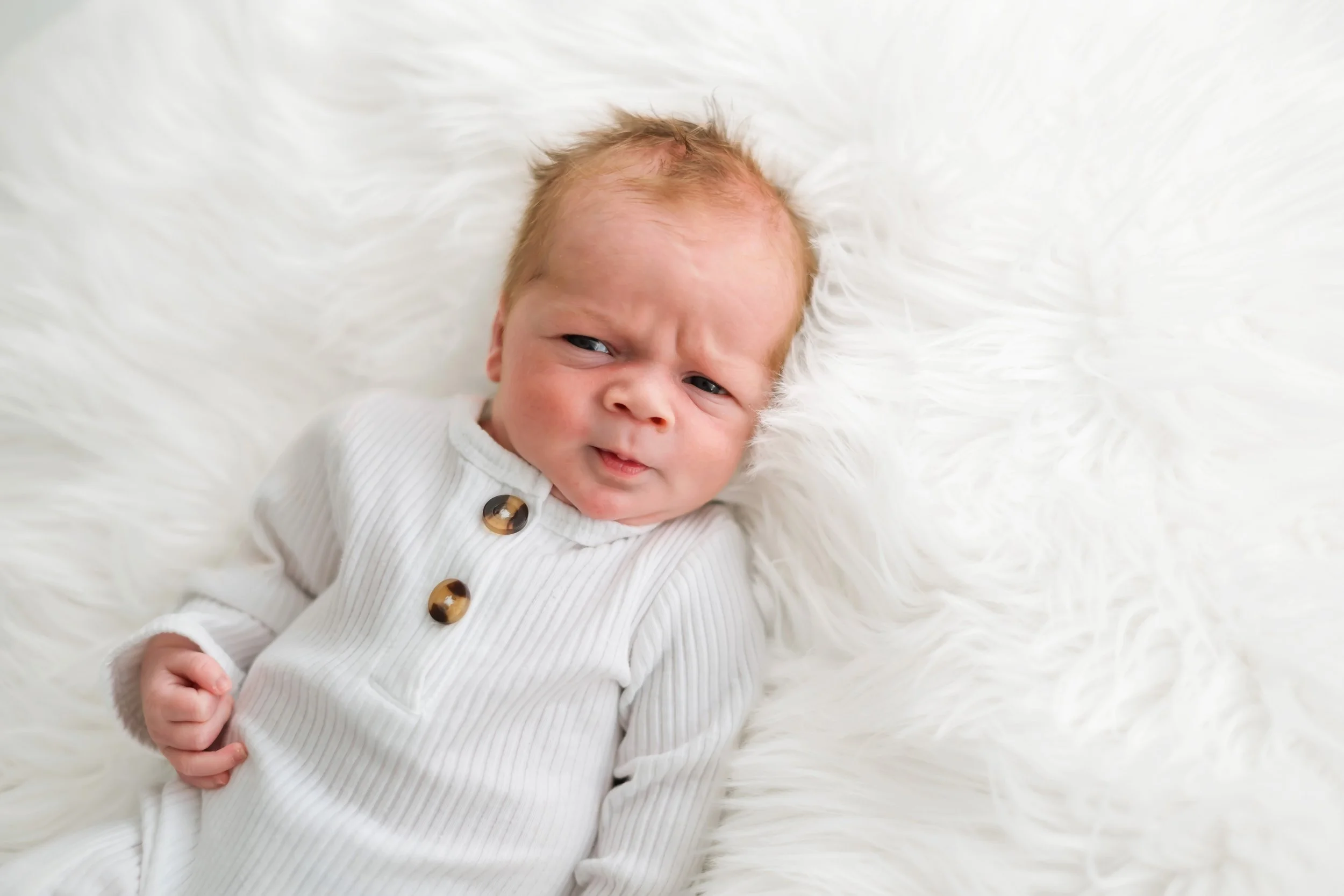 Simple white newborn set up and baby alert and awake