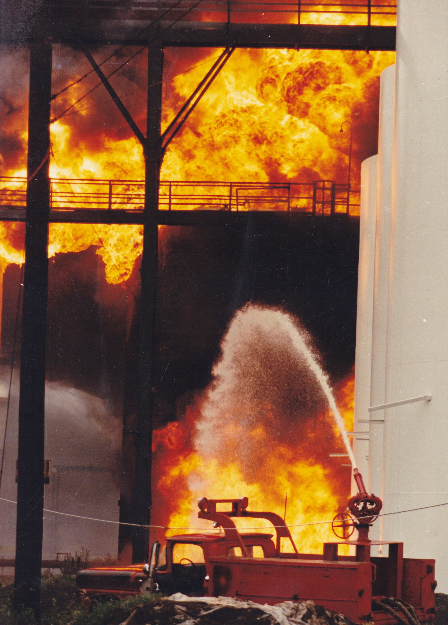 A massive fuel depo fire in Bayonne New Jersey in 1984 destroyed several fuel storage tanks, injuring several workers. Crossed a swamp and climbed a fence to get inside the terminal. By Todd Maisel